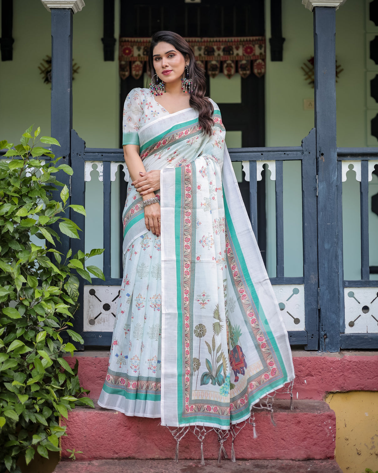 Ivory pure cotton linen saree with elephant motif and floral pattern green and pink borders and tassels on edges mameraa