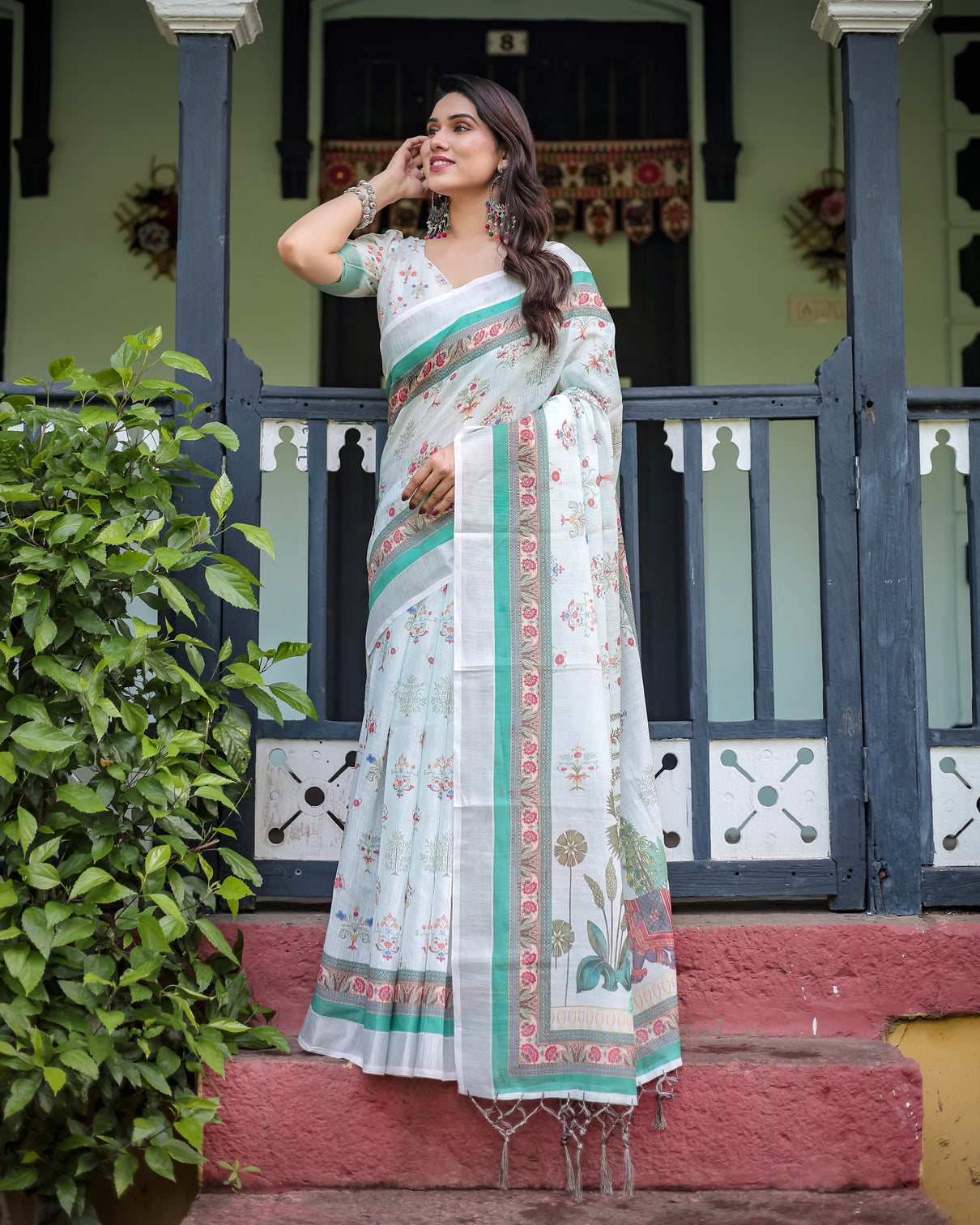 Ivory pure cotton linen saree with elephant motif and floral pattern green and pink borders and tassels on edges