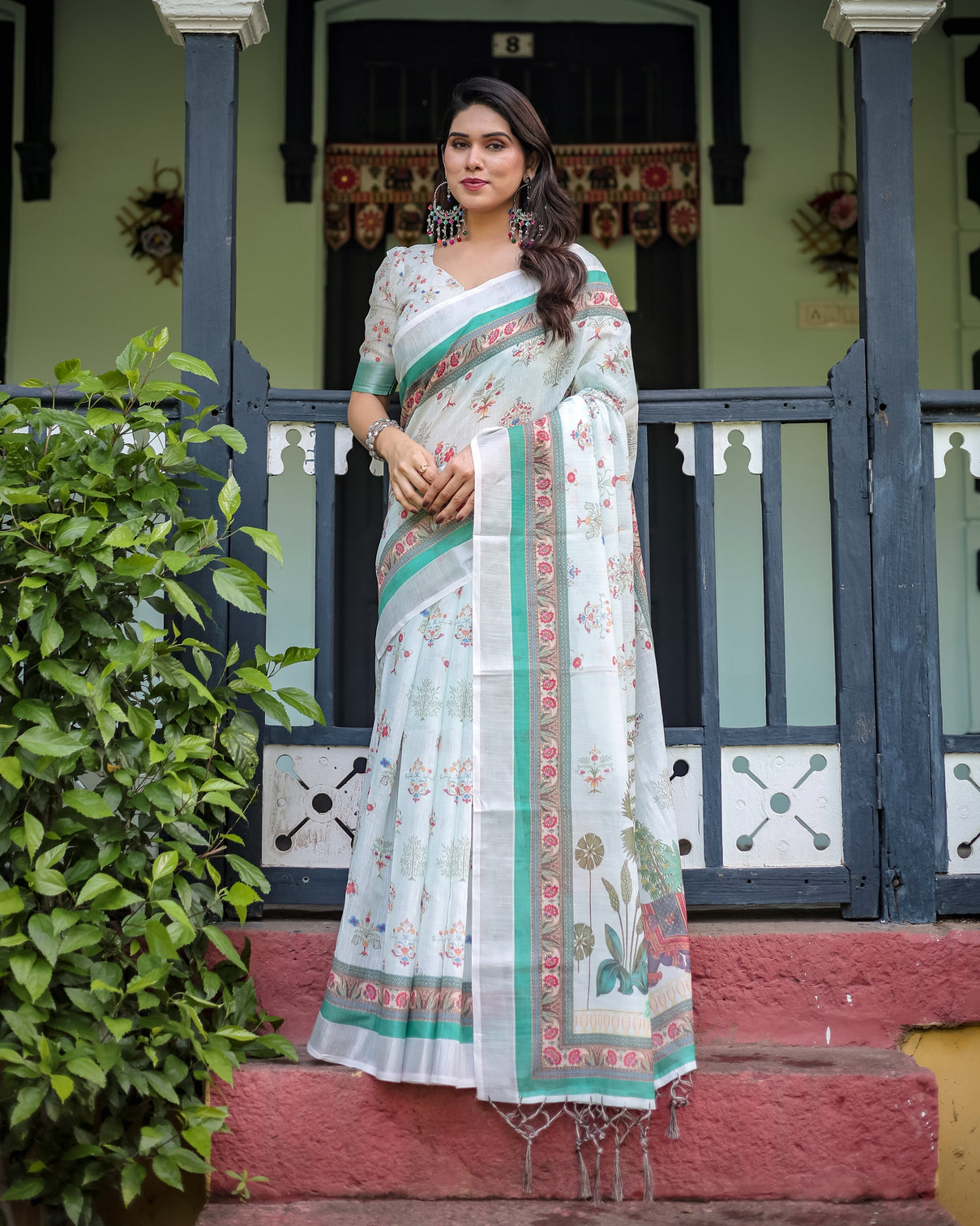 Ivory pure cotton linen saree with elephant motif and floral pattern green and pink borders and tassels on edges