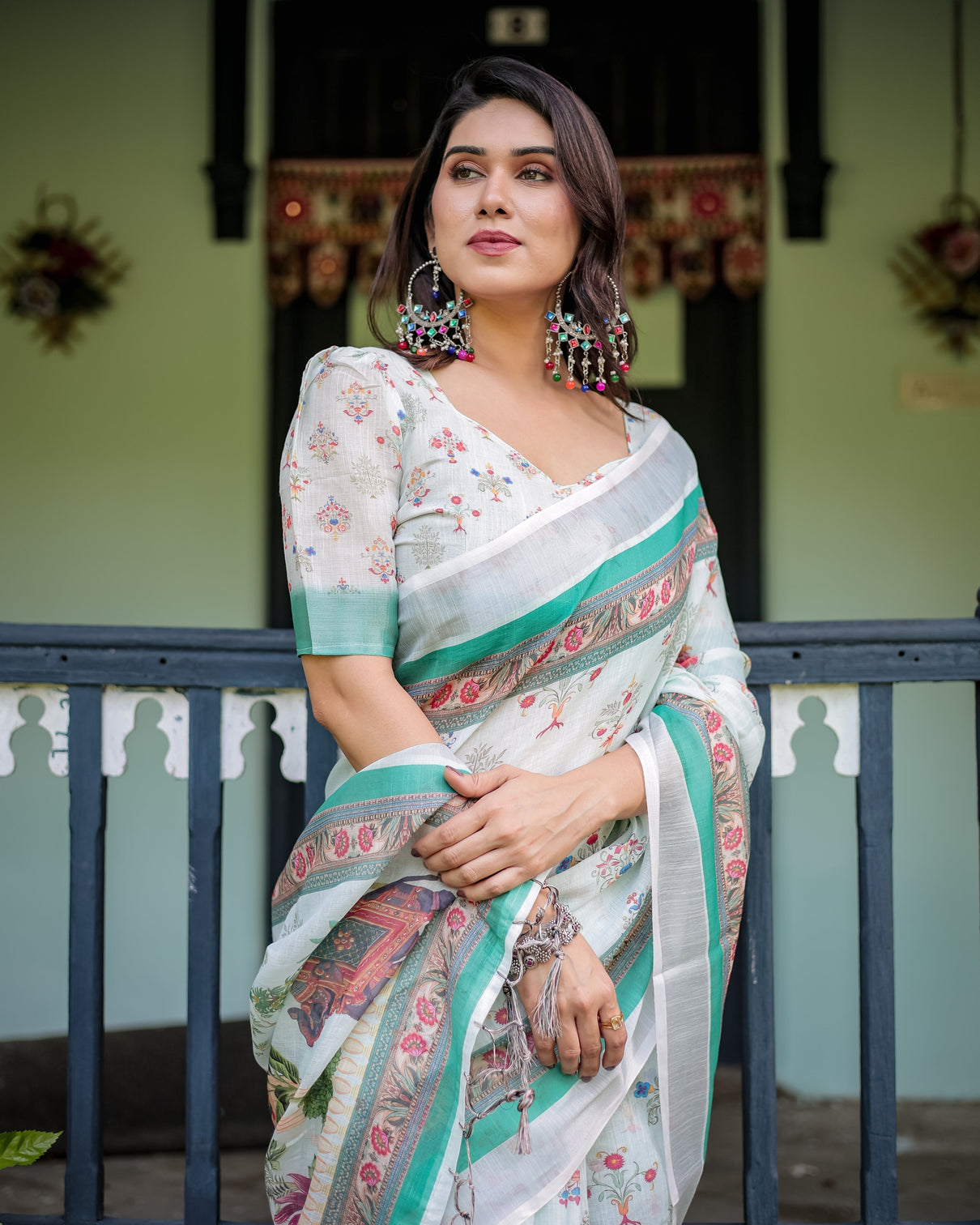 Ivory pure cotton linen saree with elephant motif and floral pattern green and pink borders and tassels on edges
