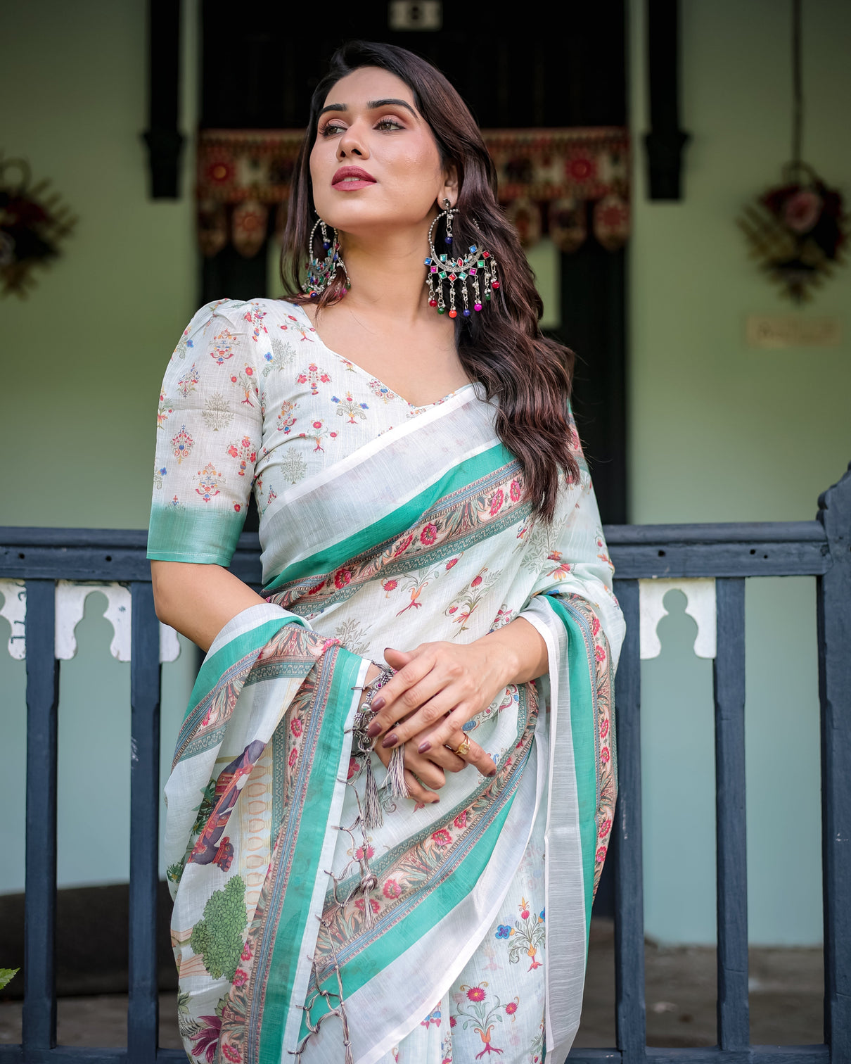 Ivory pure cotton linen saree with elephant motif and floral pattern green and pink borders and tassels on edges