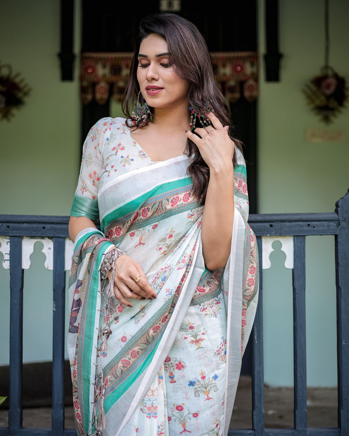 Ivory pure cotton linen saree with elephant motif and floral pattern green and pink borders and tassels on edges