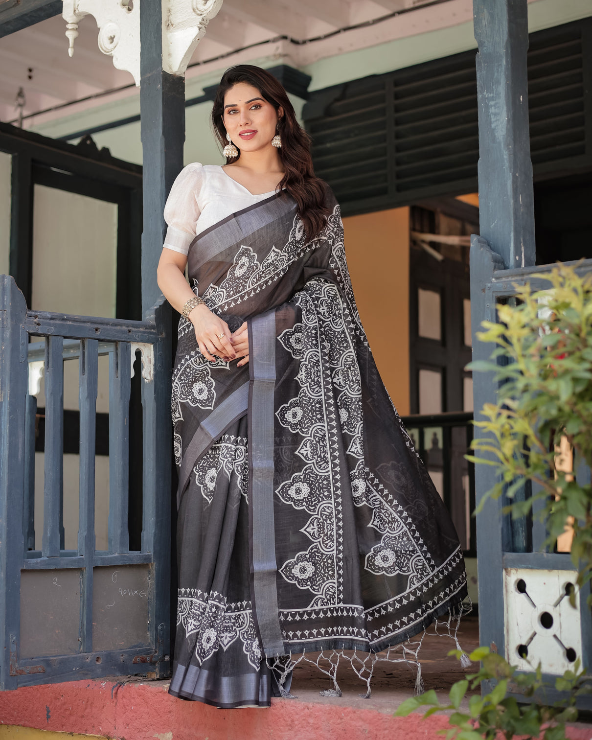 Black and white pure cotton linen saree with intricate floral design and tassels on edges