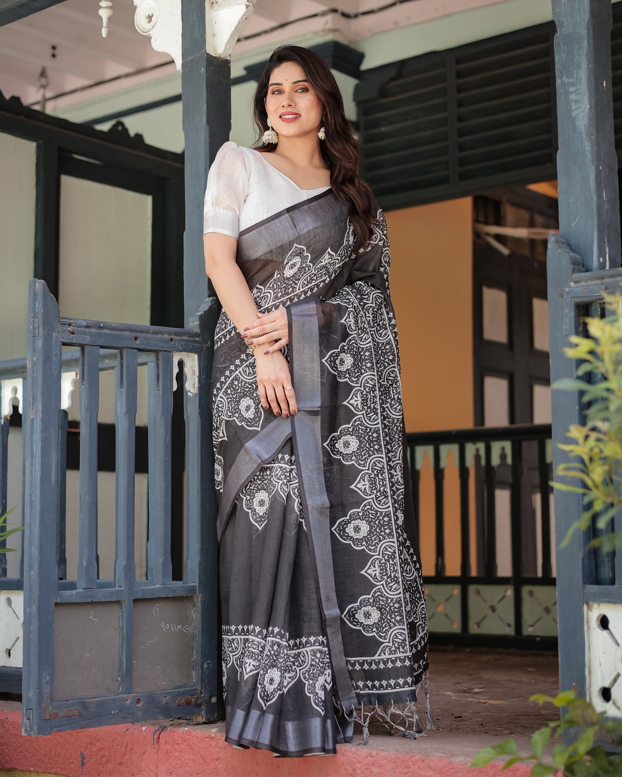 Black and white pure cotton linen saree with intricate floral design and tassels on edges