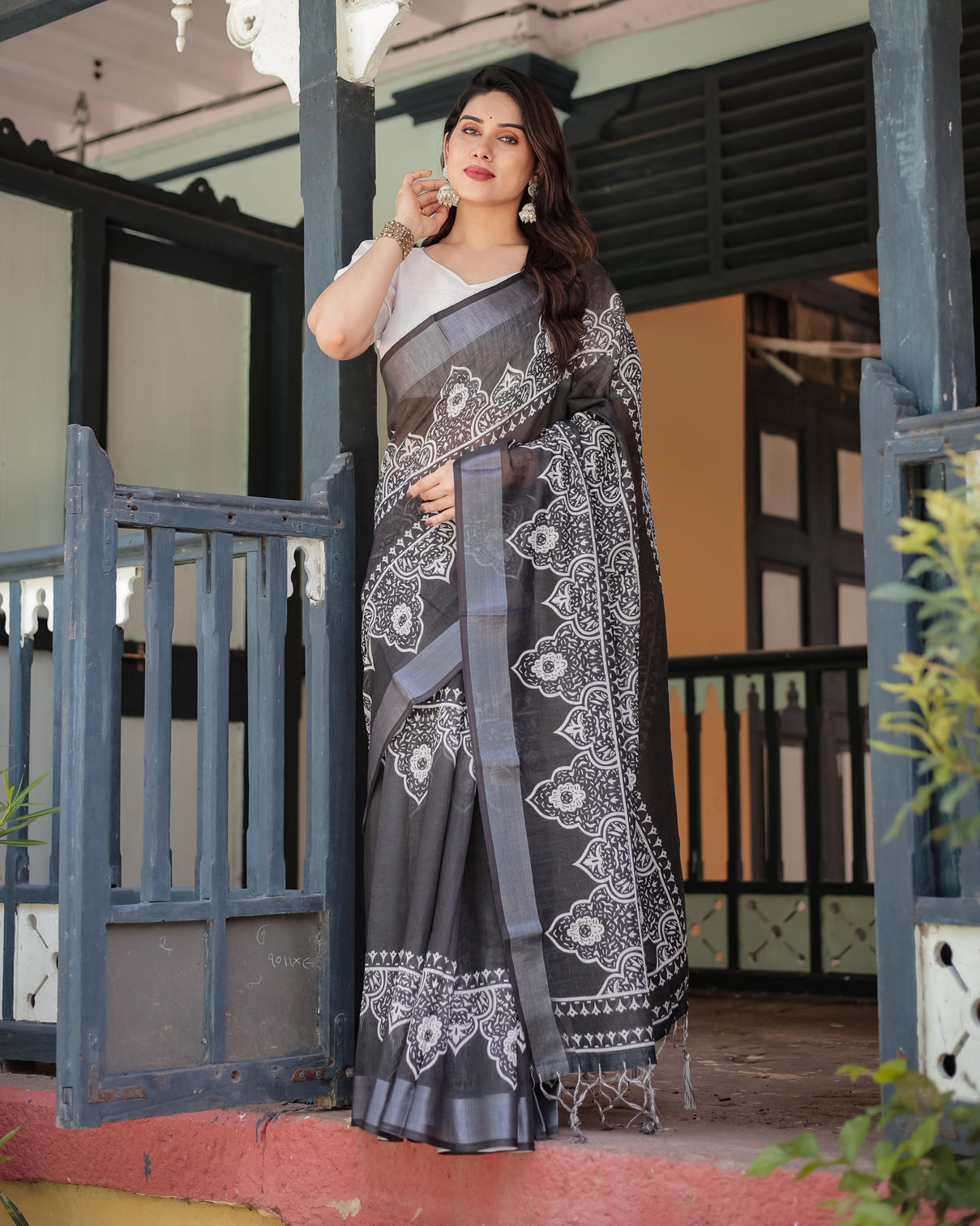 Black and white pure cotton linen saree with intricate floral design and tassels on edges