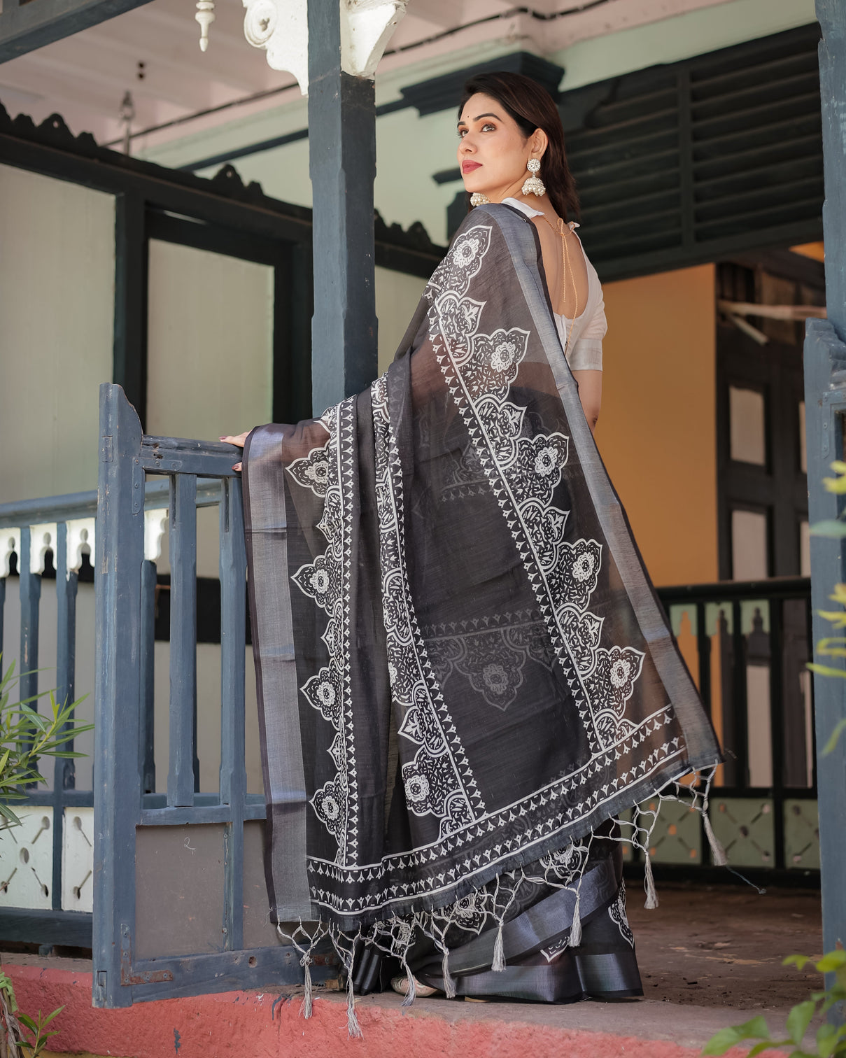 Black and white pure cotton linen saree with intricate floral design and tassels on edges
