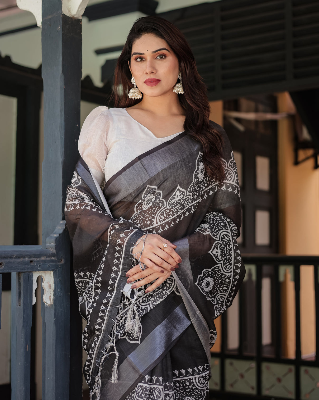 Black and white pure cotton linen saree with intricate floral design and tassels on edges