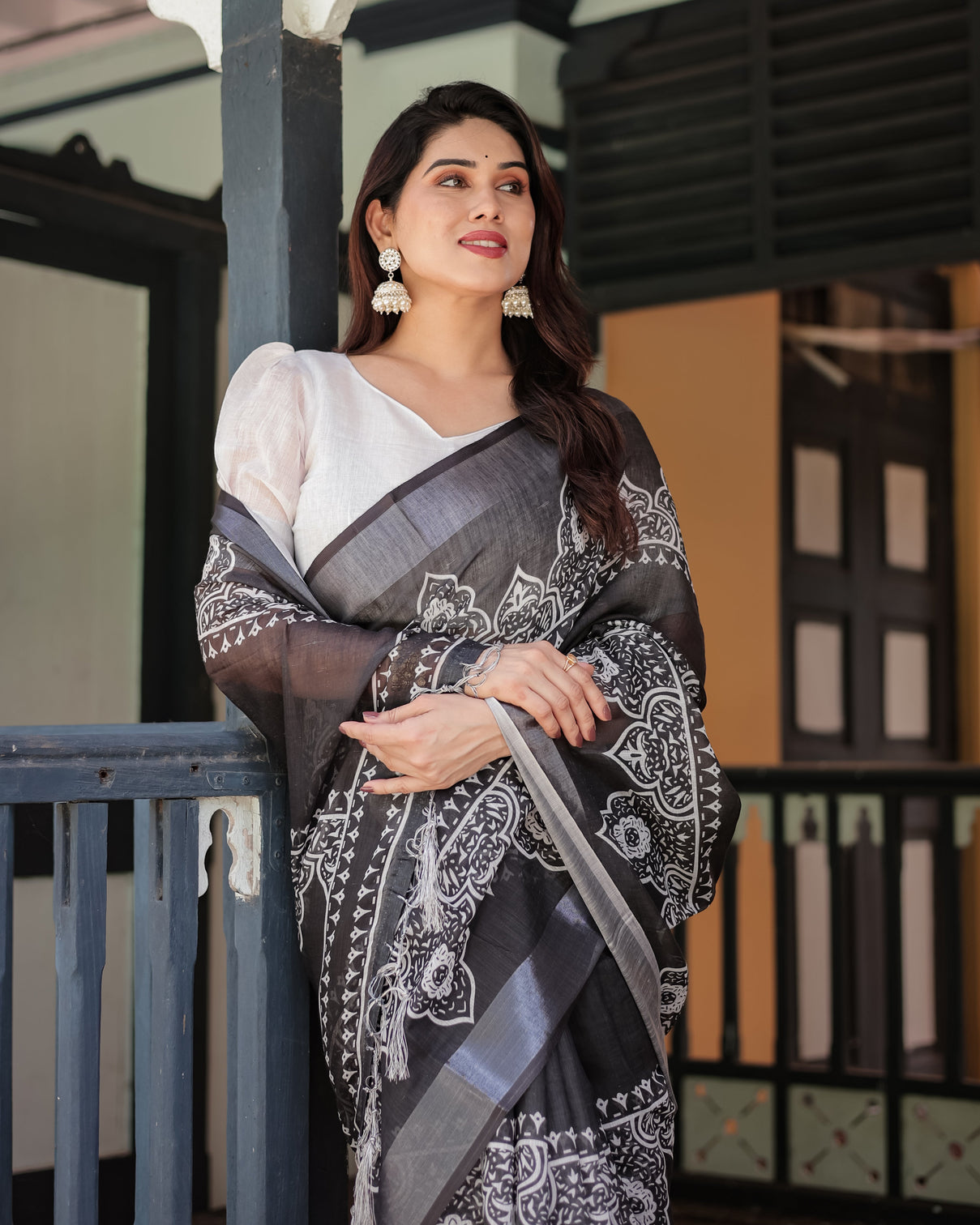 Black and white pure cotton linen saree with intricate floral design and tassels on edges