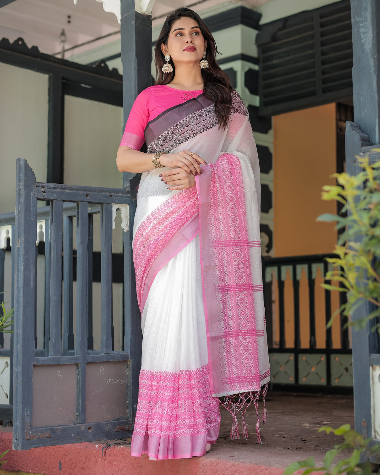 Elegant white and pink pure cotton linen saree with intricate floral and geometric border design and tassels on edges