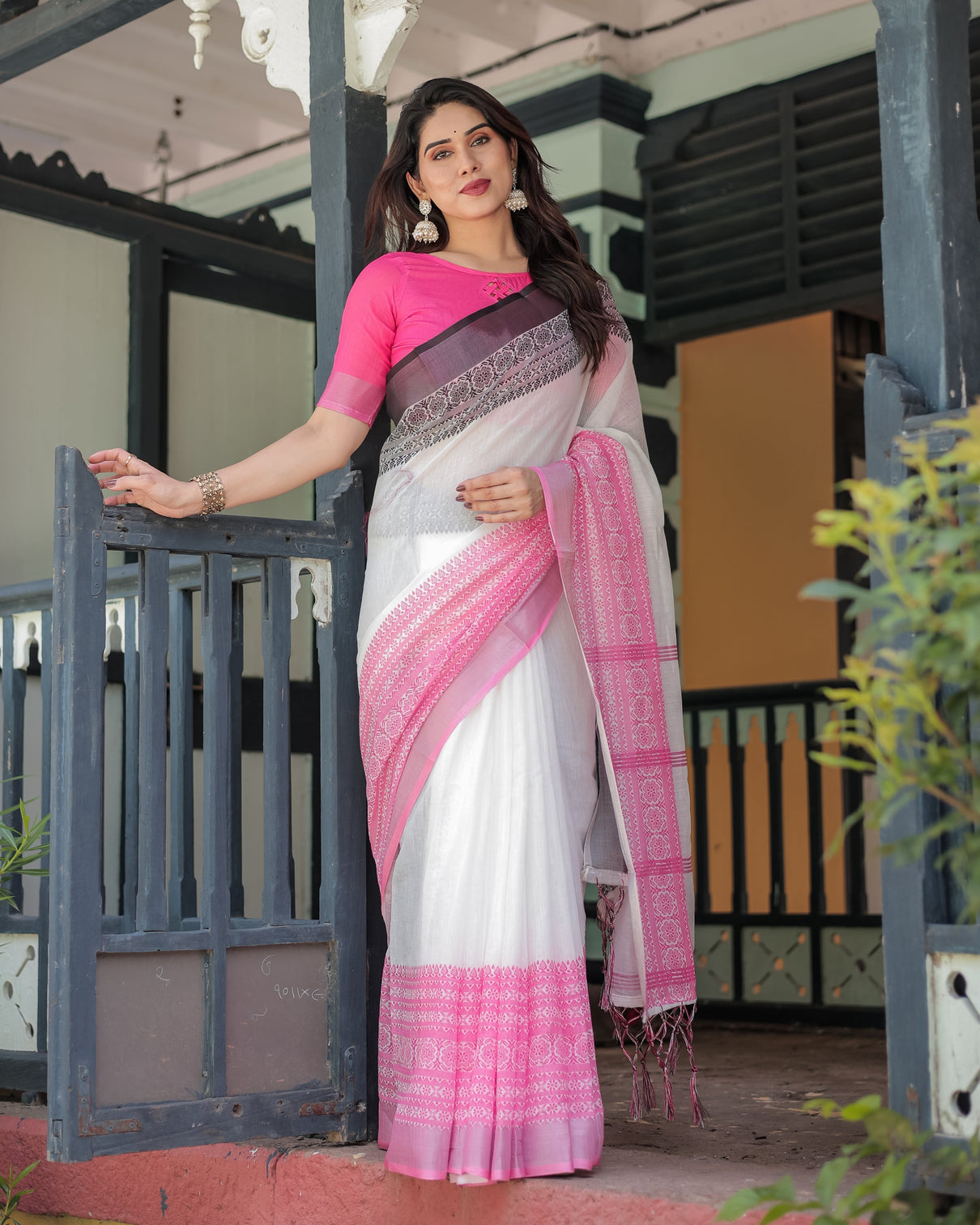 Elegant white and pink pure cotton linen saree with intricate floral and geometric border design and tassels on edges