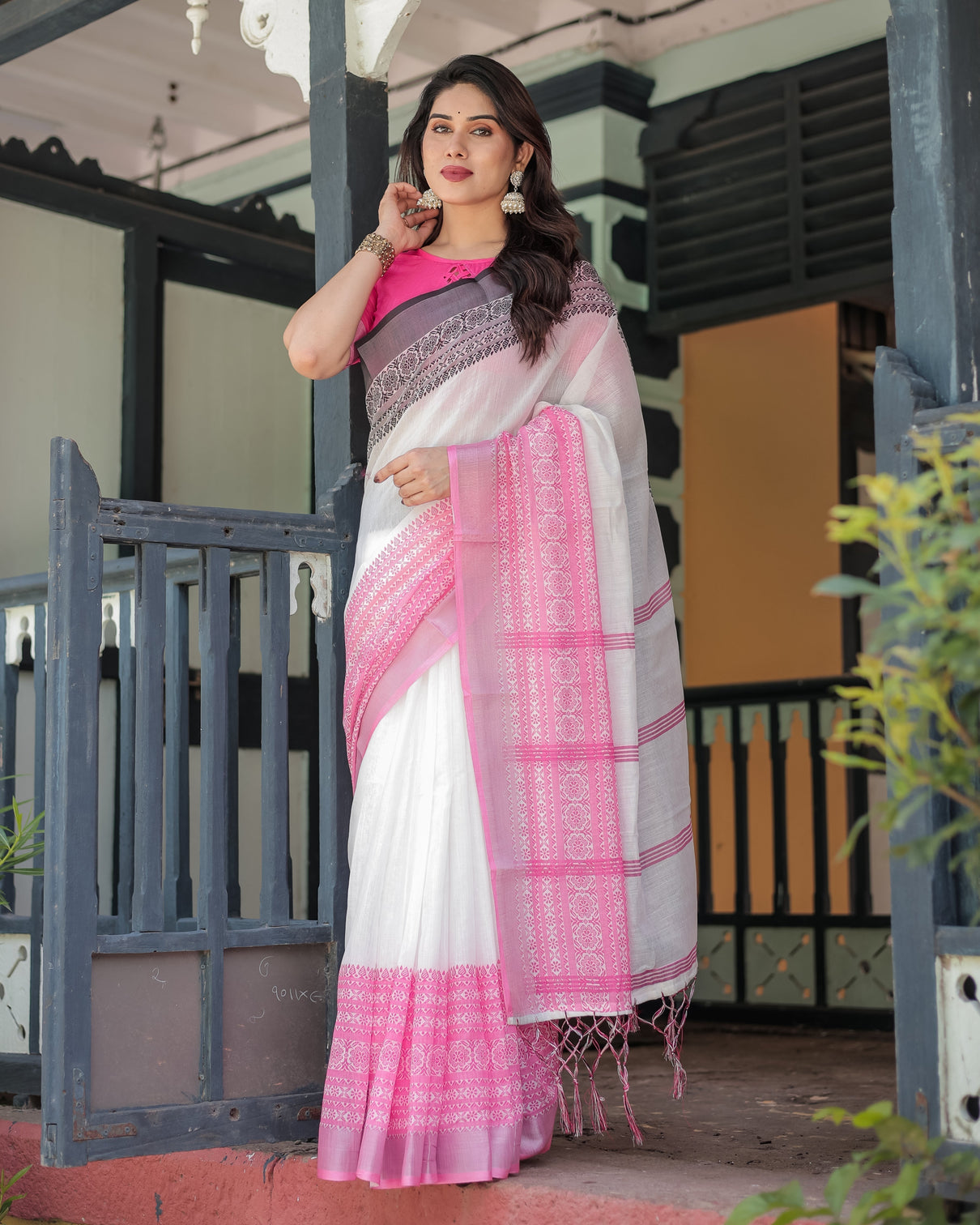 Elegant white and pink pure cotton linen saree with intricate floral and geometric border design and tassels on edges
