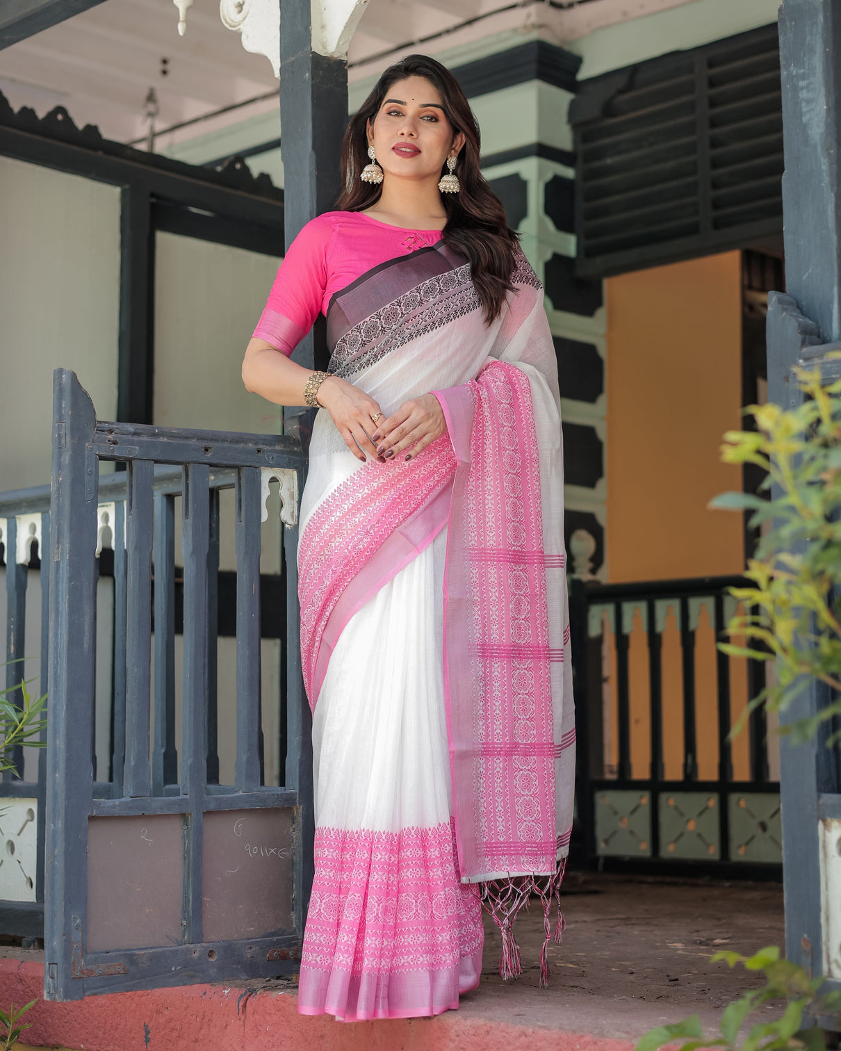 Elegant white and pink pure cotton linen saree with intricate floral and geometric border design and tassels on edges