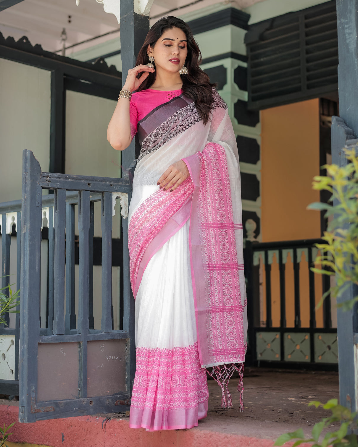 Elegant white and pink pure cotton linen saree with intricate floral and geometric border design and tassels on edges