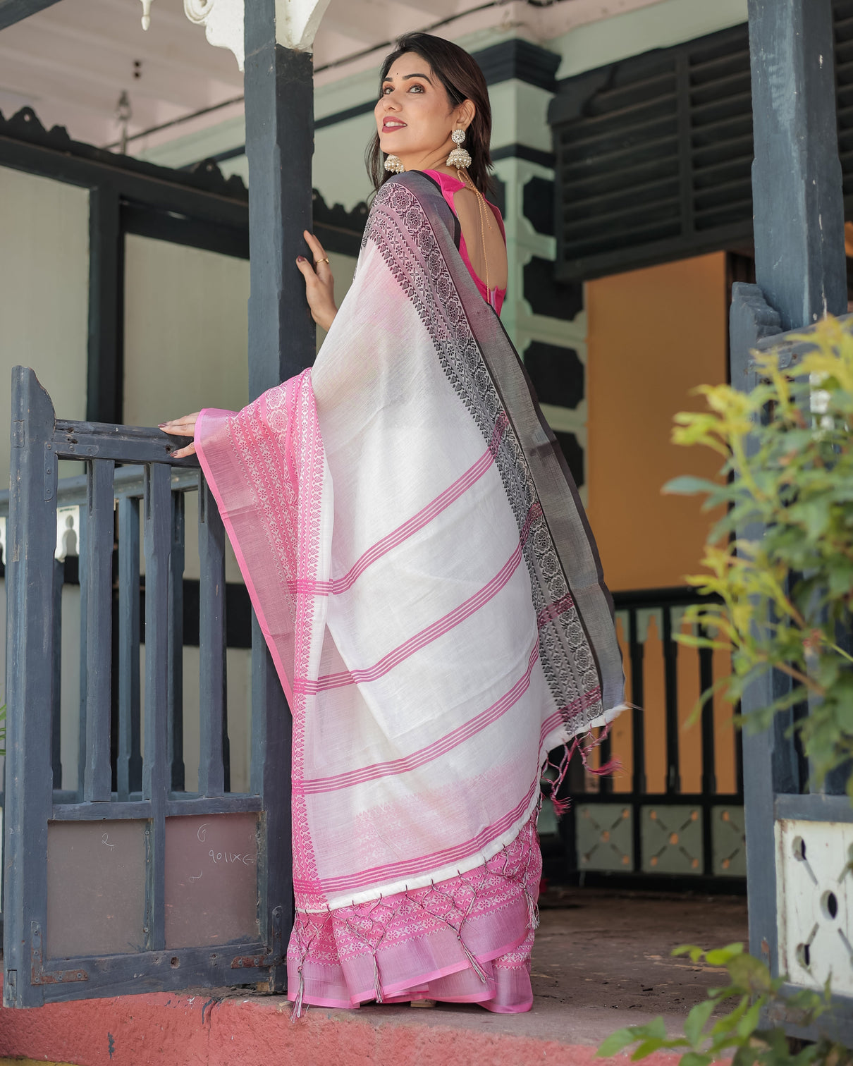 Elegant white and pink pure cotton linen saree with intricate floral and geometric border design and tassels on edges