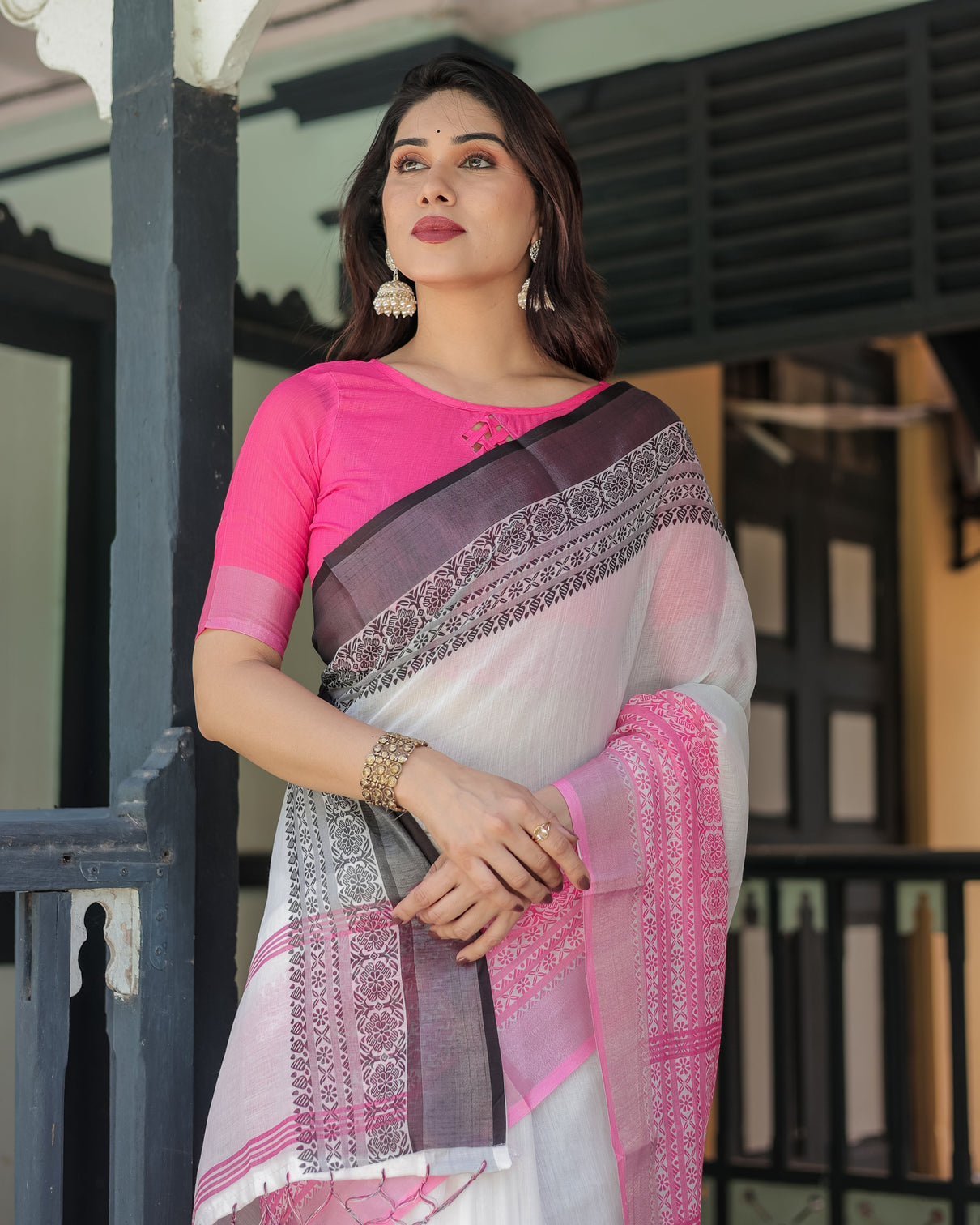 Elegant white and pink pure cotton linen saree with intricate floral and geometric border design and tassels on edges