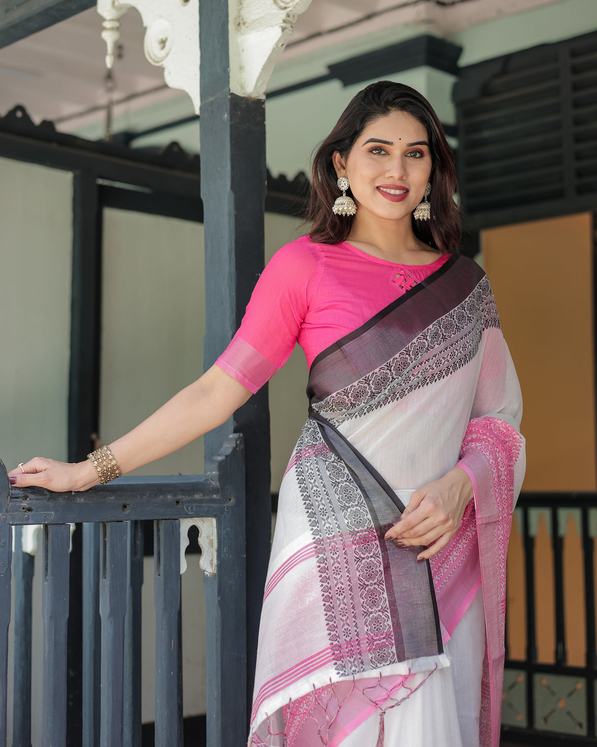 Elegant white and pink pure cotton linen saree with intricate floral and geometric border design and tassels on edges