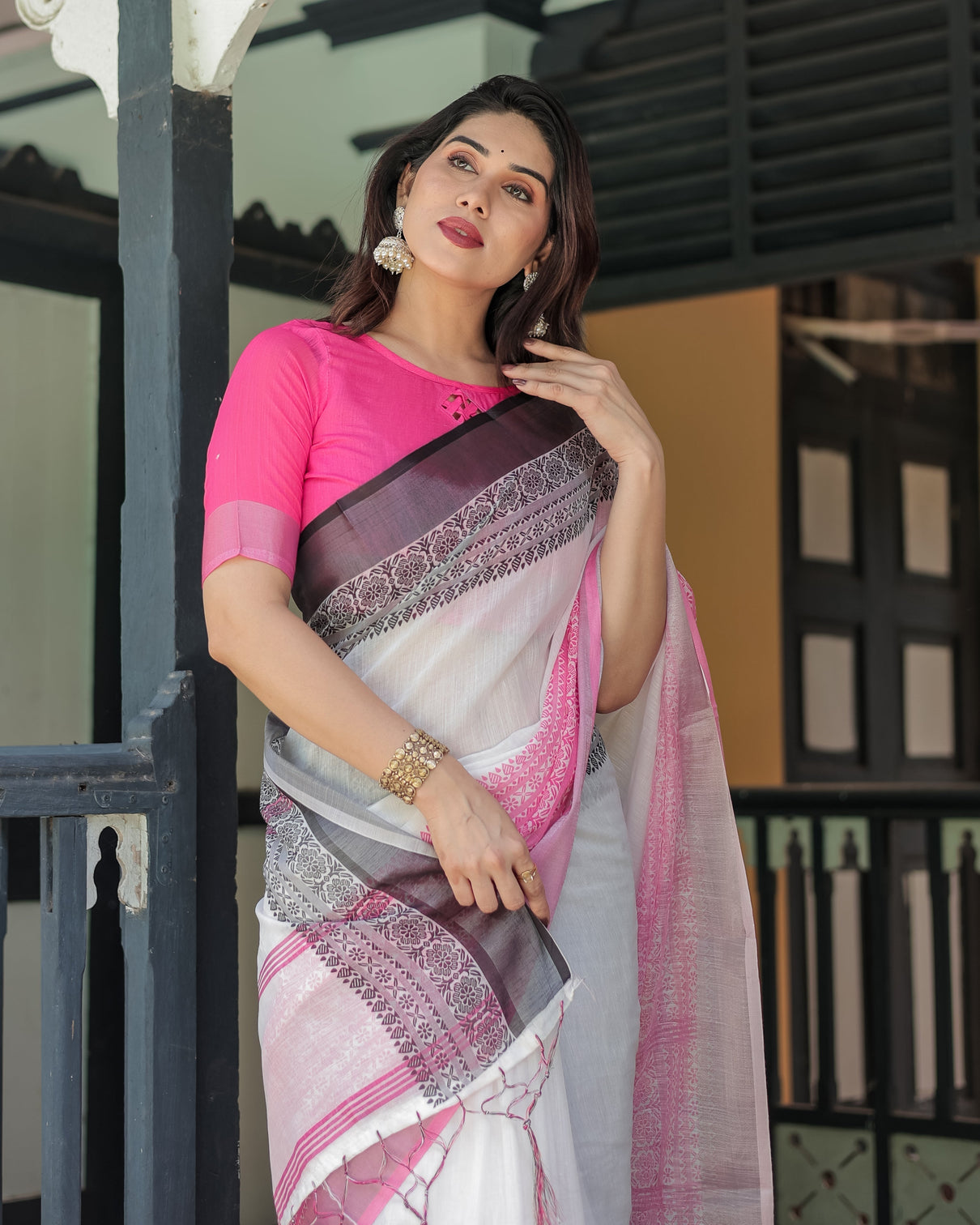 Elegant white and pink pure cotton linen saree with intricate floral and geometric border design and tassels on edges