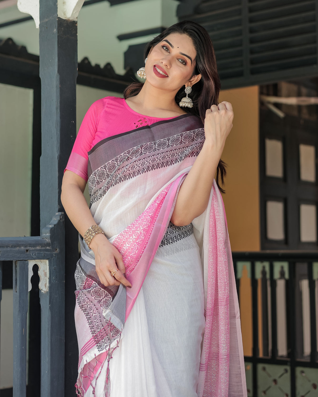 Elegant white and pink pure cotton linen saree with intricate floral and geometric border design and tassels on edges
