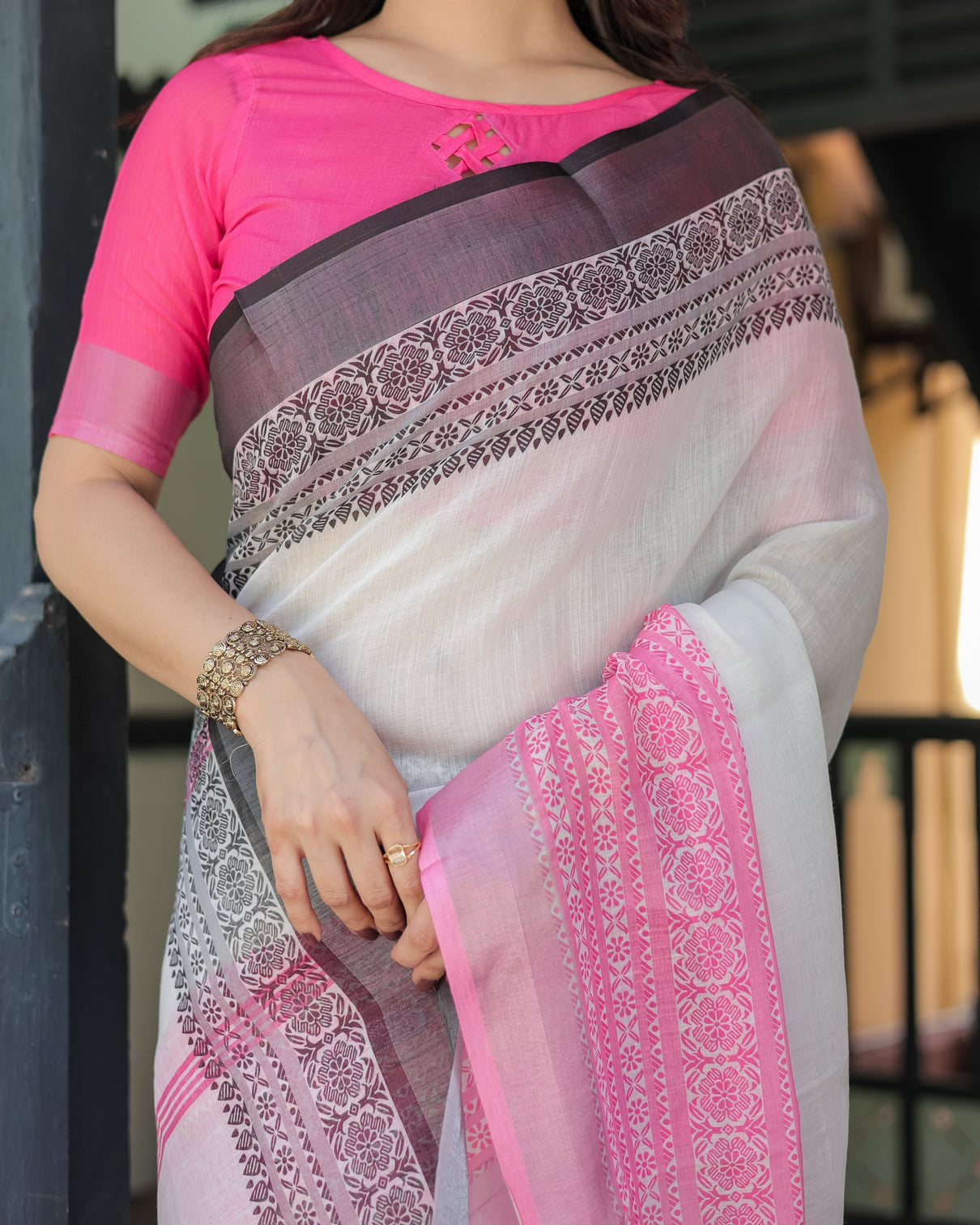 Elegant white and pink pure cotton linen saree with intricate floral and geometric border design and tassels on edges