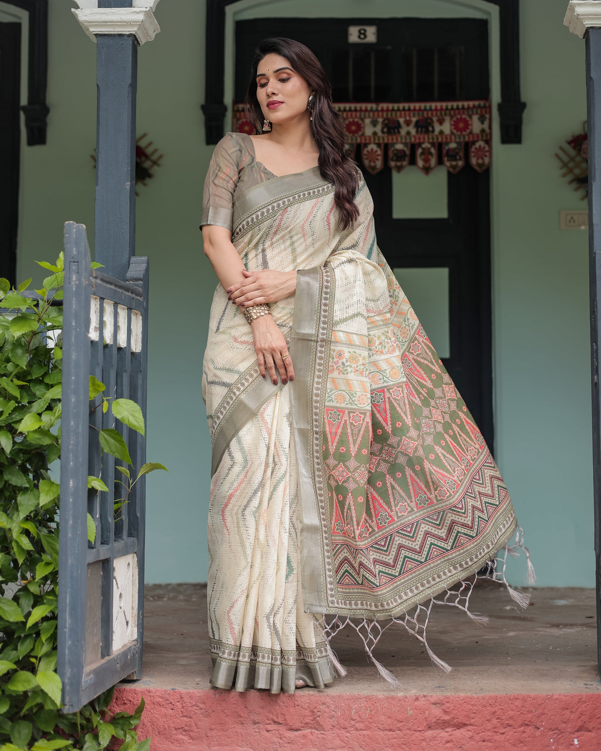 Cream and olive green pure cotton linen saree with floral and geometric print and tassels on edges