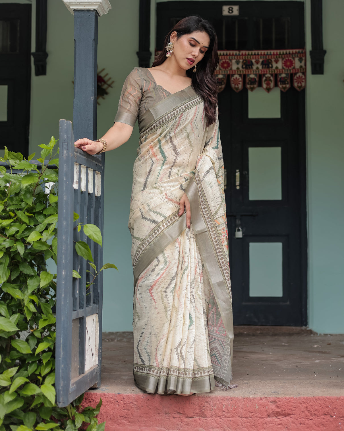 Cream and olive green pure cotton linen saree with floral and geometric print and tassels on edges