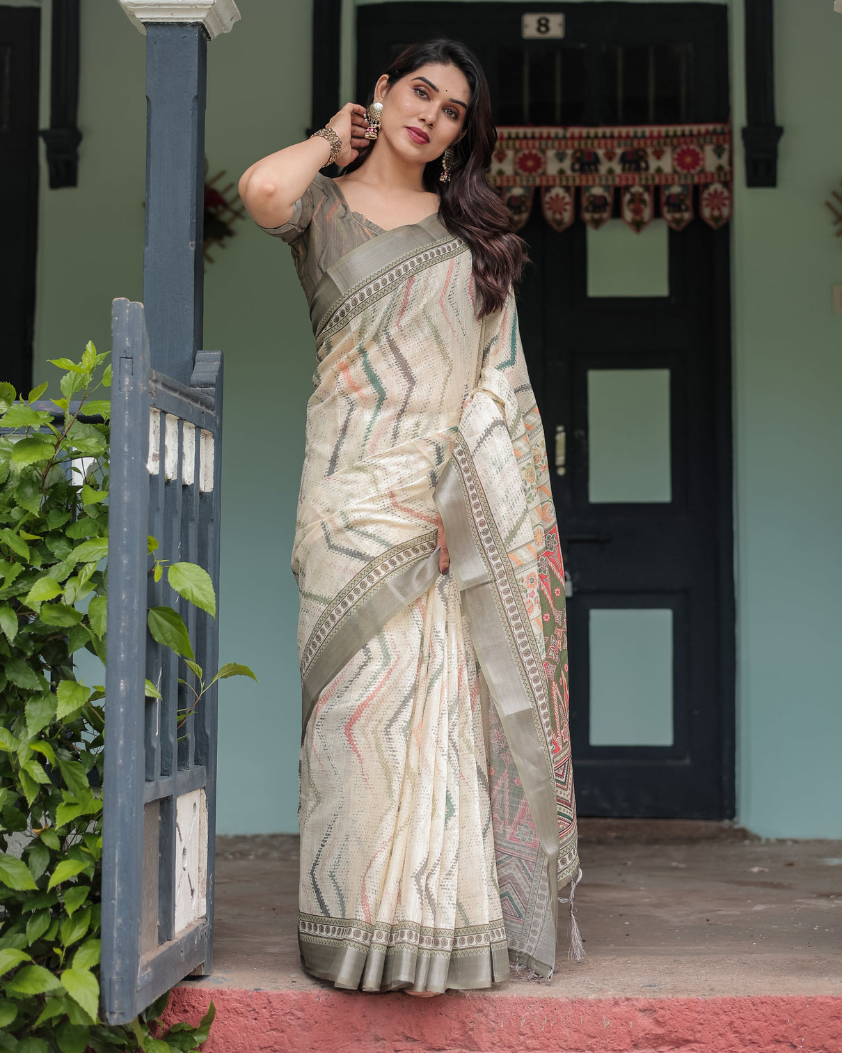 Cream and olive green pure cotton linen saree with floral and geometric print and tassels on edges