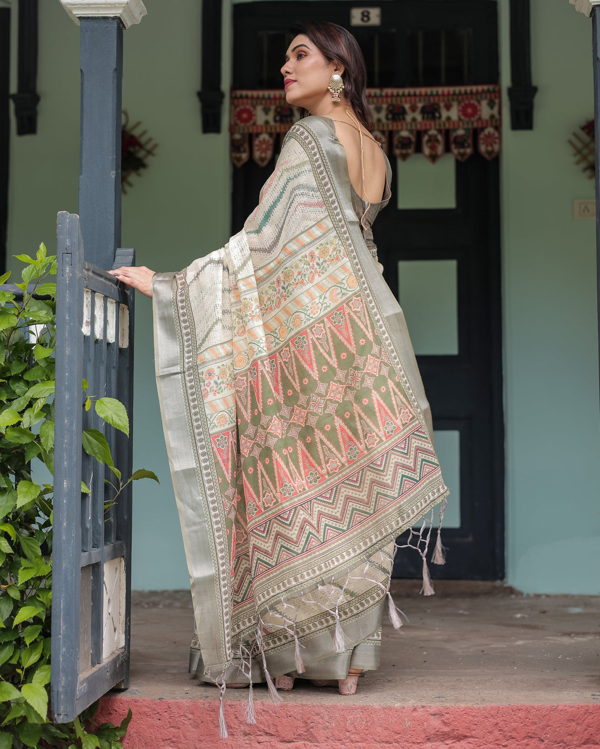 Cream and olive green pure cotton linen saree with floral and geometric print and tassels on edges