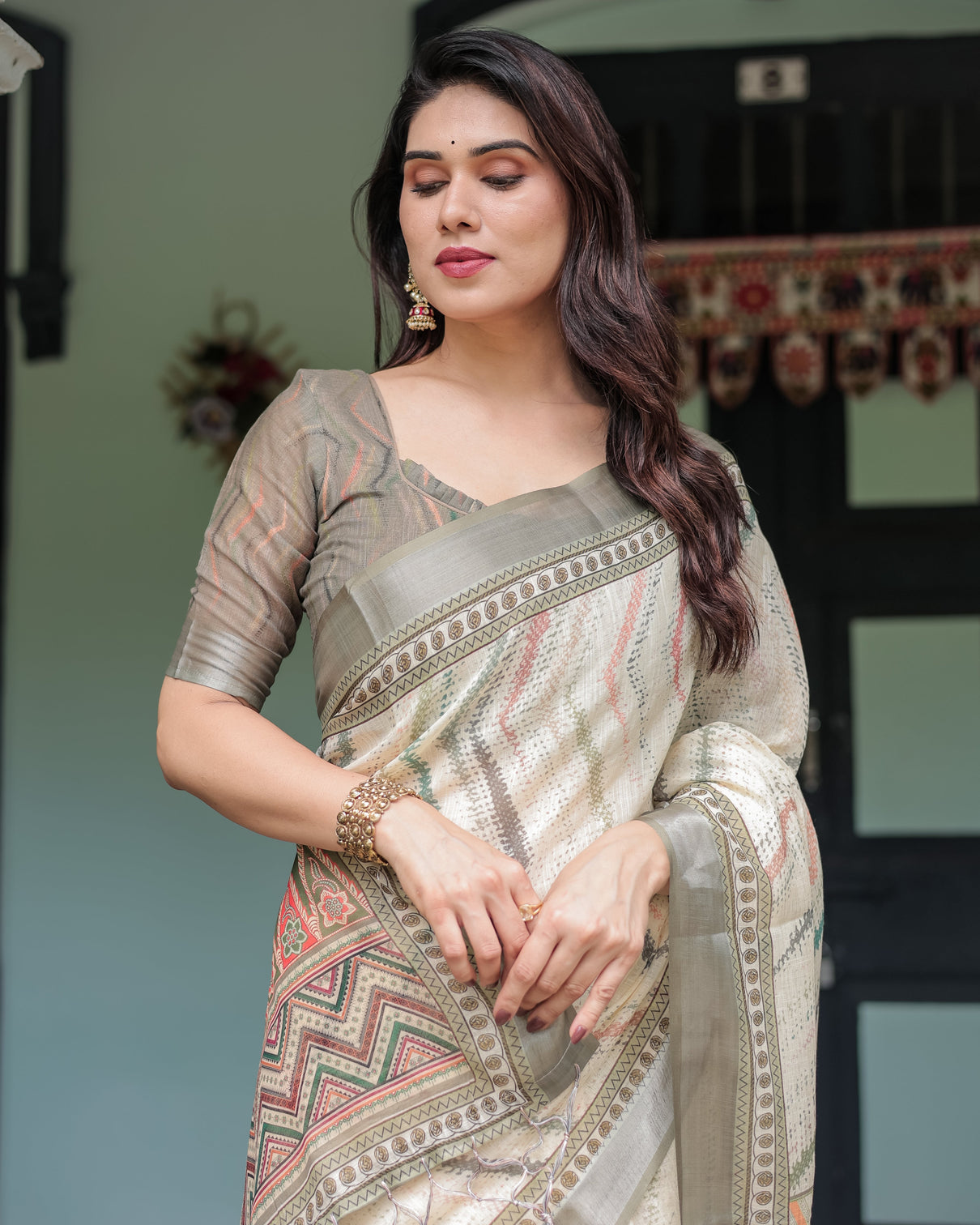 Cream and olive green pure cotton linen saree with floral and geometric print and tassels on edges