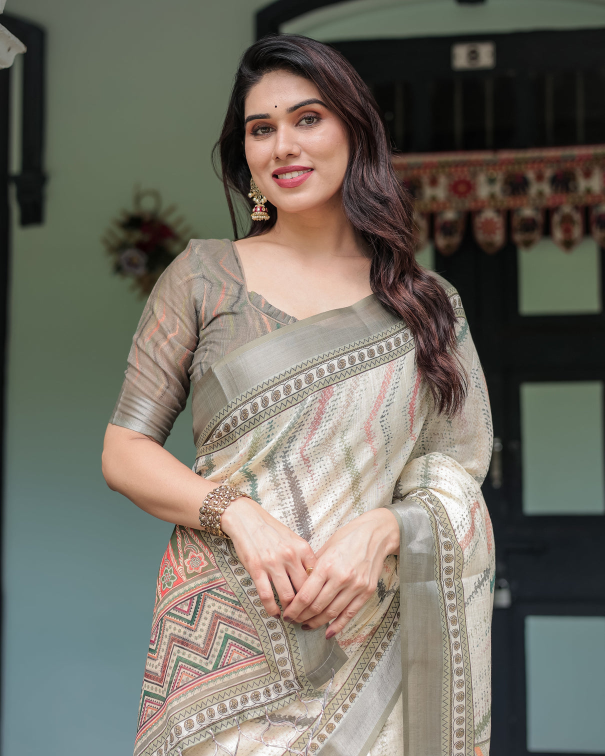 Cream and olive green pure cotton linen saree with floral and geometric print and tassels on edges