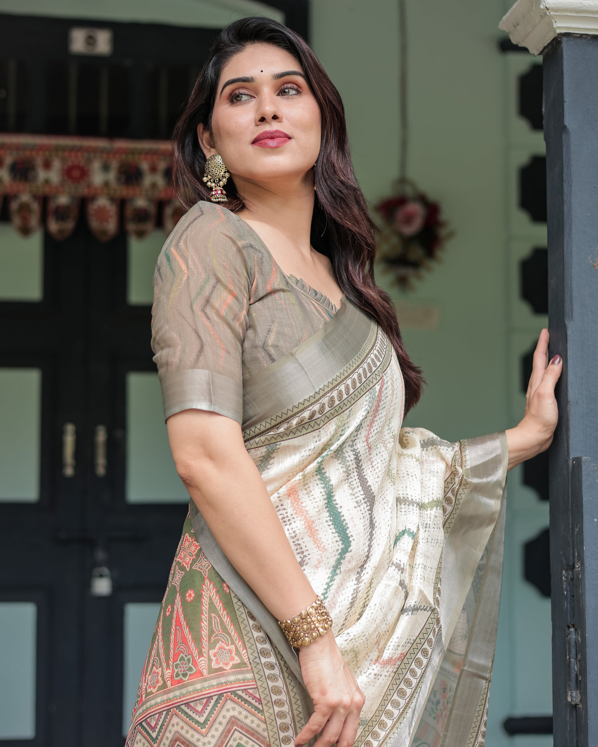 Cream and olive green pure cotton linen saree with floral and geometric print and tassels on edges