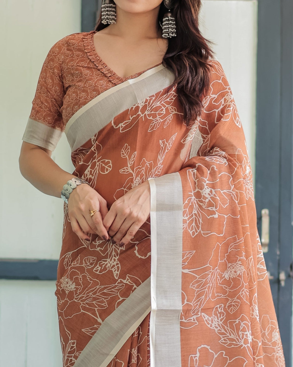 Terracotta brown floral handprinted pure cotton linen saree with tassels