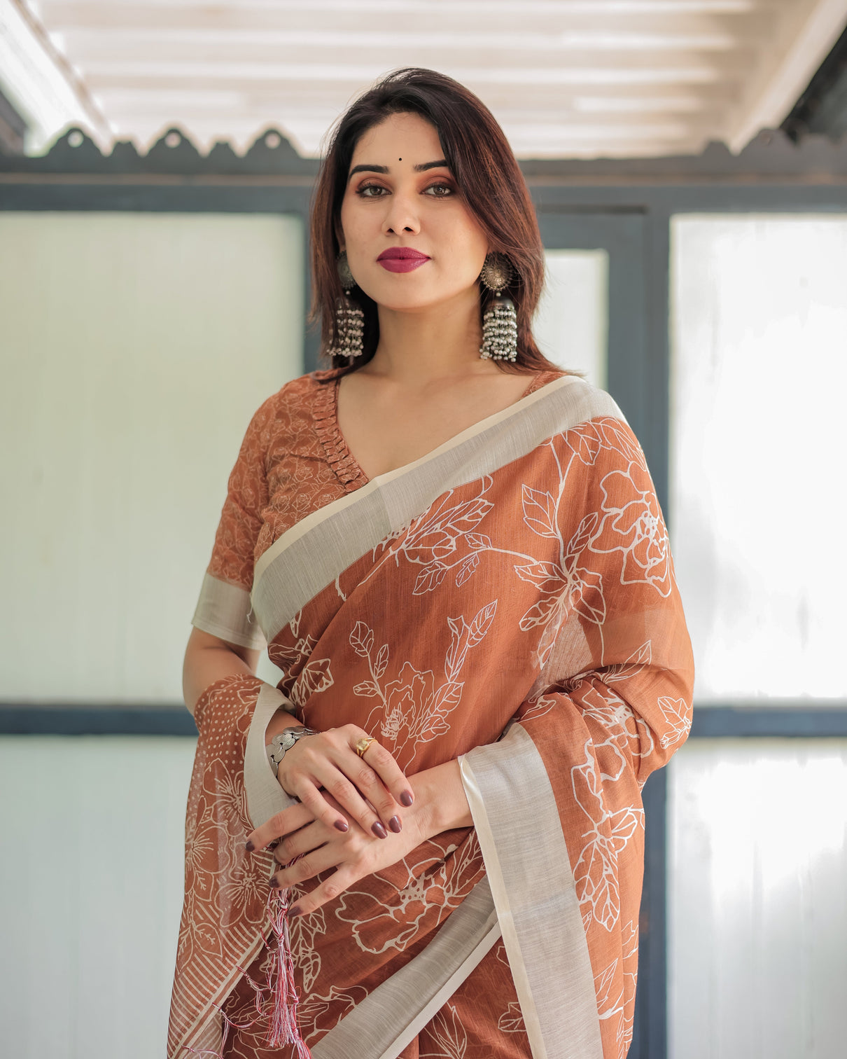 Terracotta brown floral handprinted pure cotton linen saree with tassels