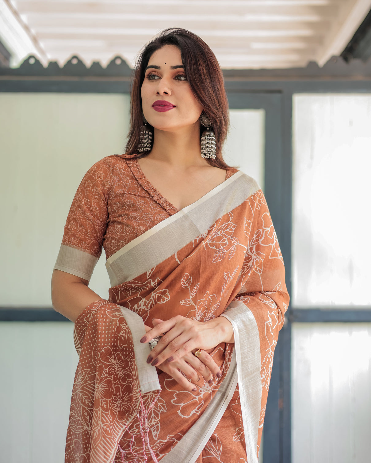 Terracotta brown floral handprinted pure cotton linen saree with tassels