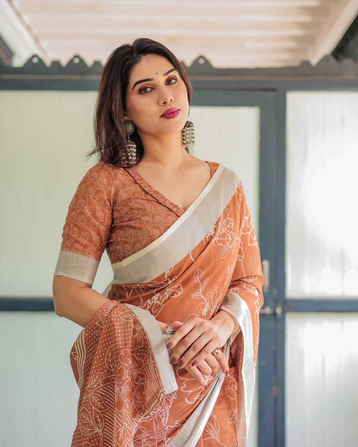 Terracotta brown floral handprinted pure cotton linen saree with tassels