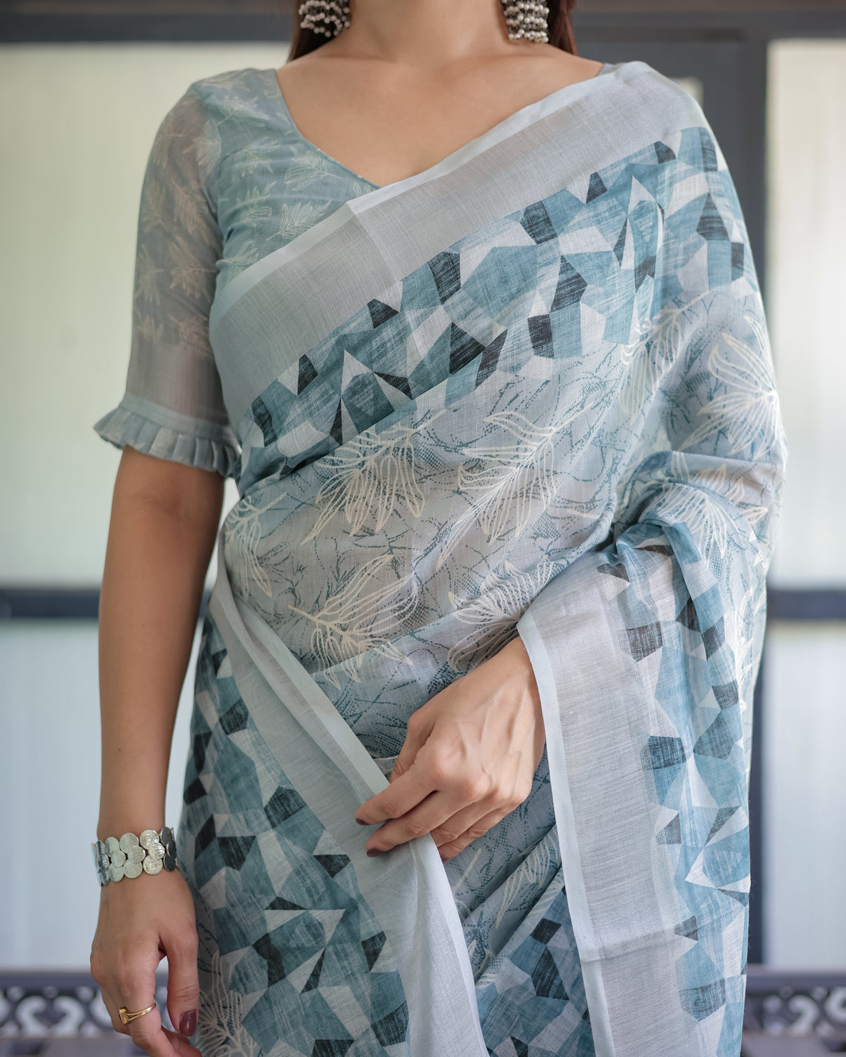 Light blue pure cotton linen saree with geometric and floral patterns blouse and tassels
