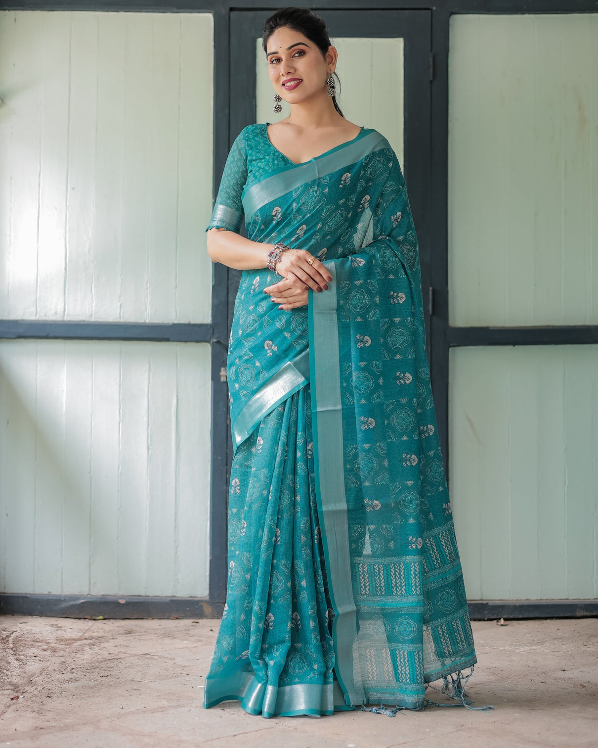 Teal green pure cotton linen saree with silver floral motifs and tassels