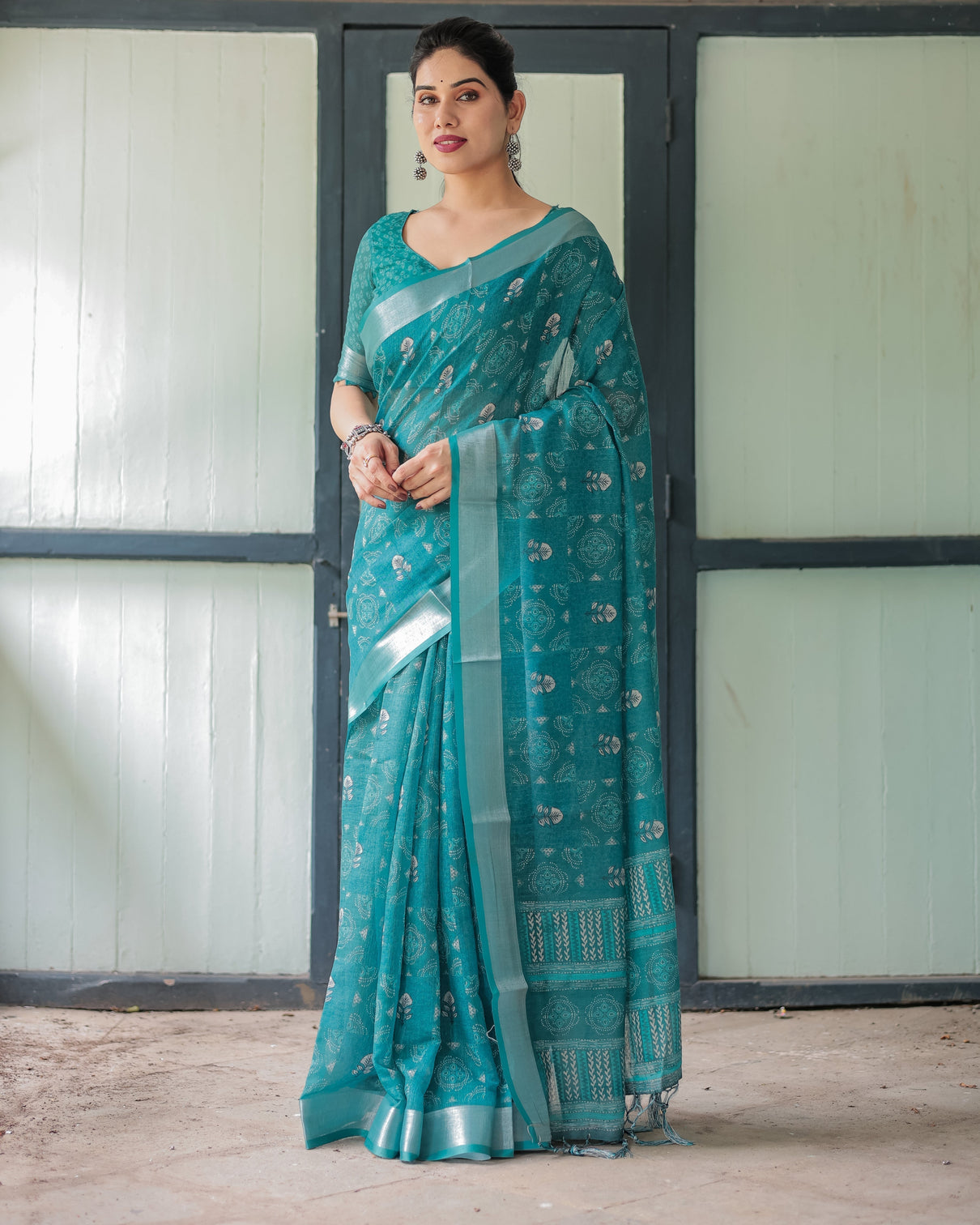 Teal green pure cotton linen saree with silver floral motifs and tassels