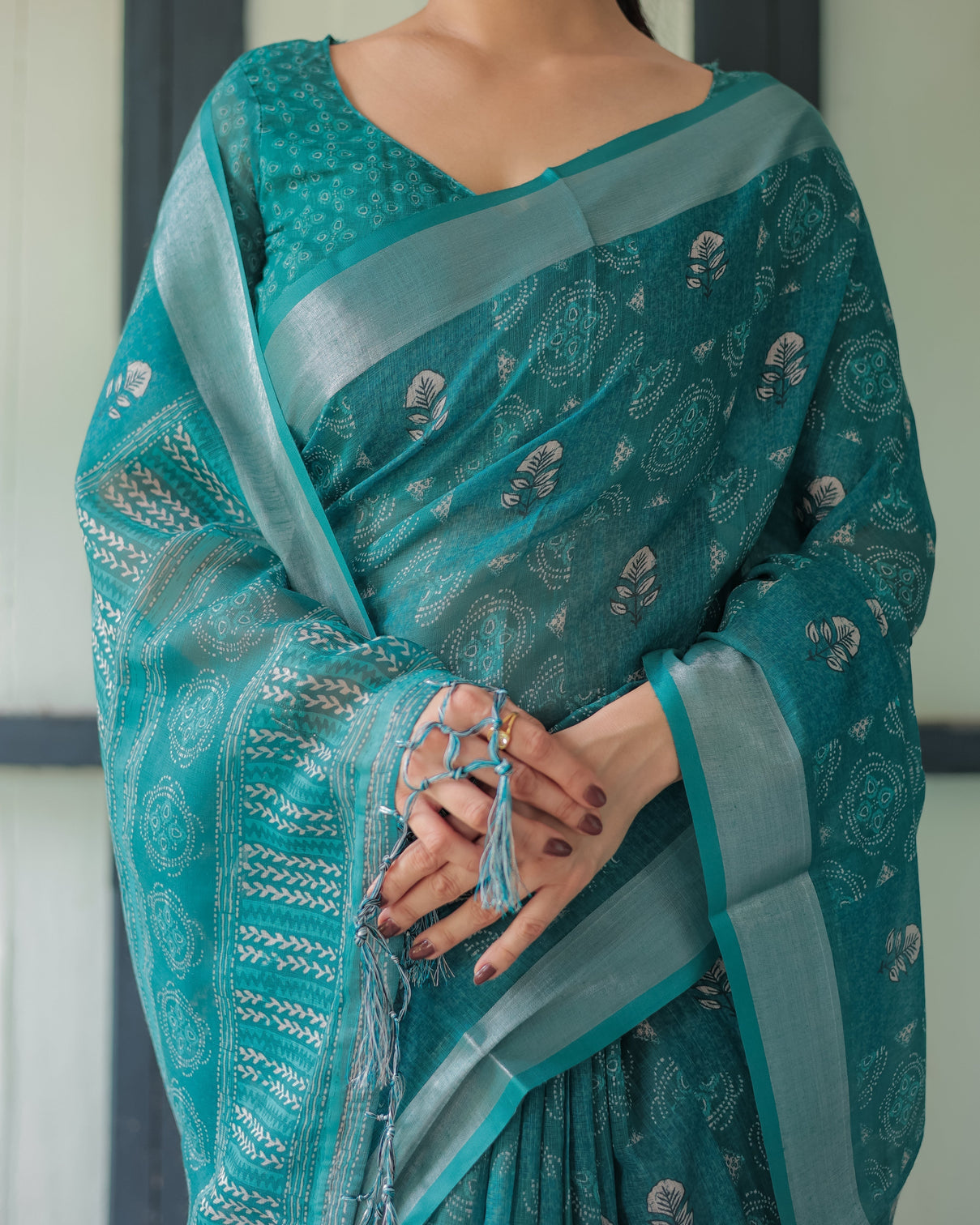 Teal green pure cotton linen saree with silver floral motifs and tassels