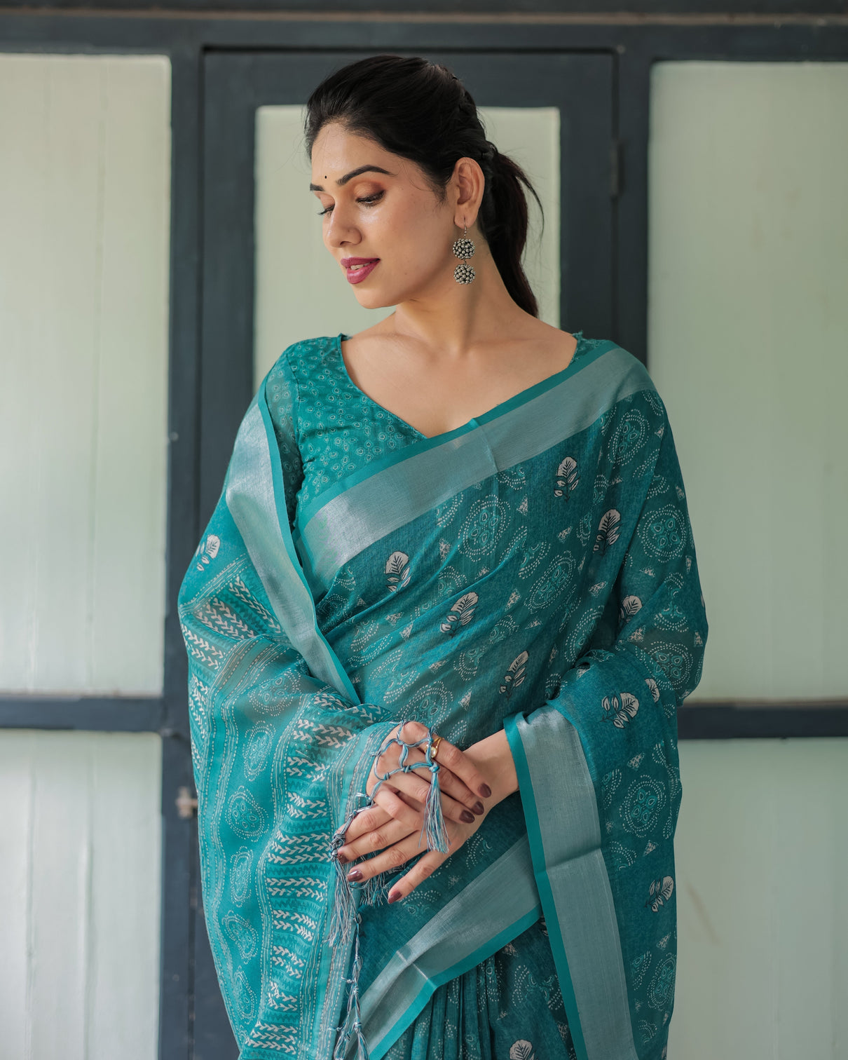 Teal green pure cotton linen saree with silver floral motifs and tassels