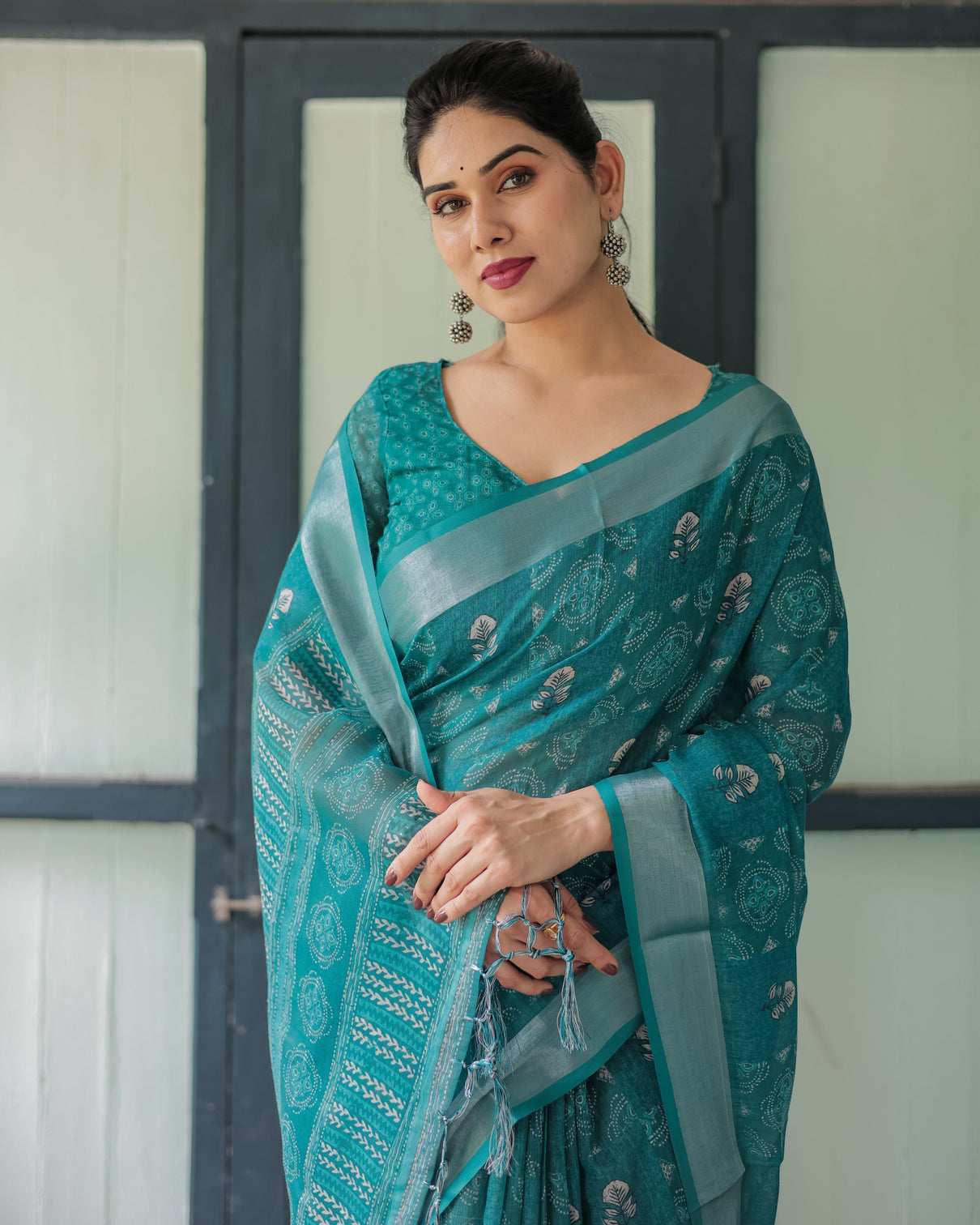 Teal green pure cotton linen saree with silver floral motifs and tassels