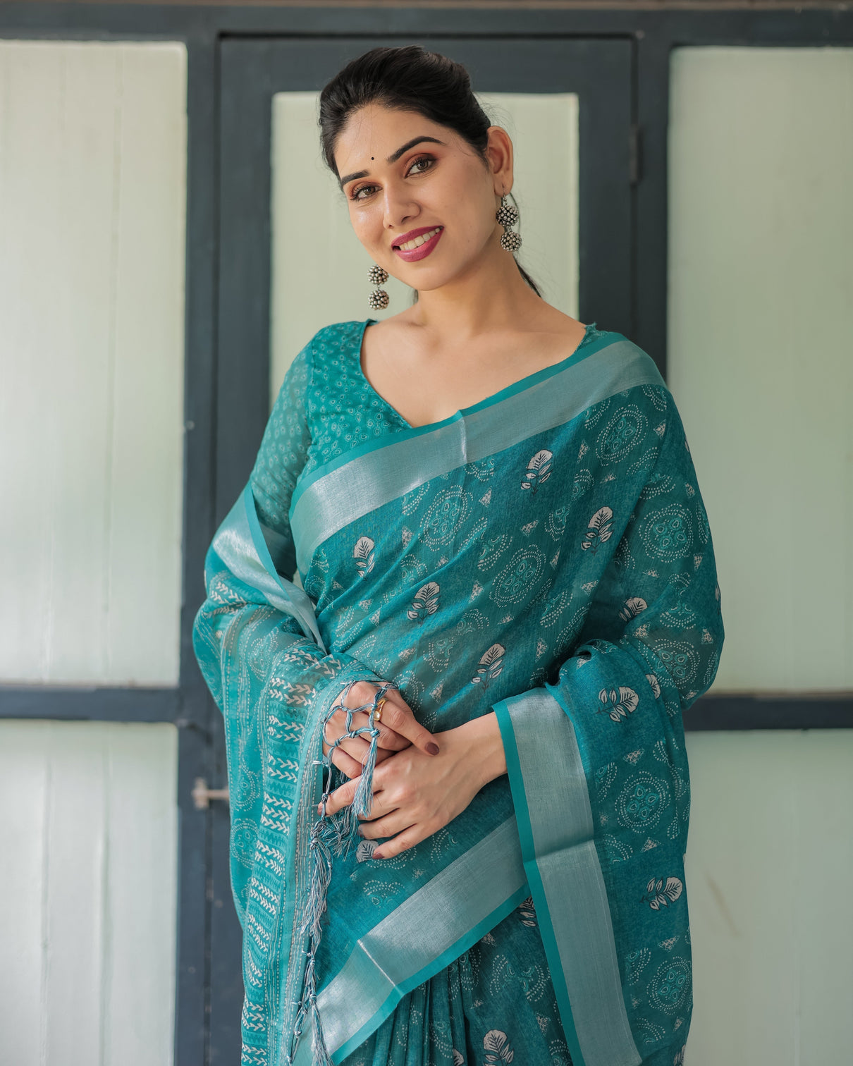 Teal green pure cotton linen saree with silver floral motifs and tassels