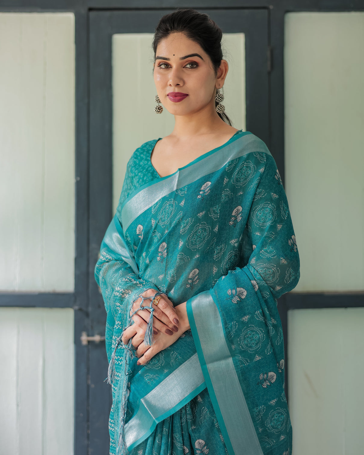 Teal green pure cotton linen saree with silver floral motifs and tassels