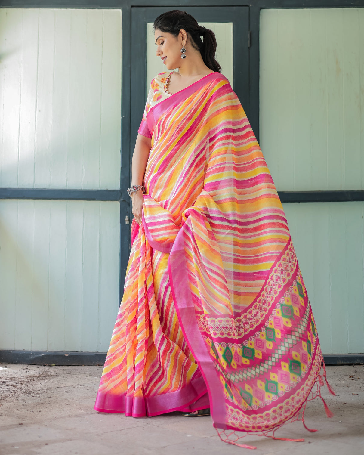 Vibrant yellow and pink ikat printed cotton linen saree with blouse and tassels