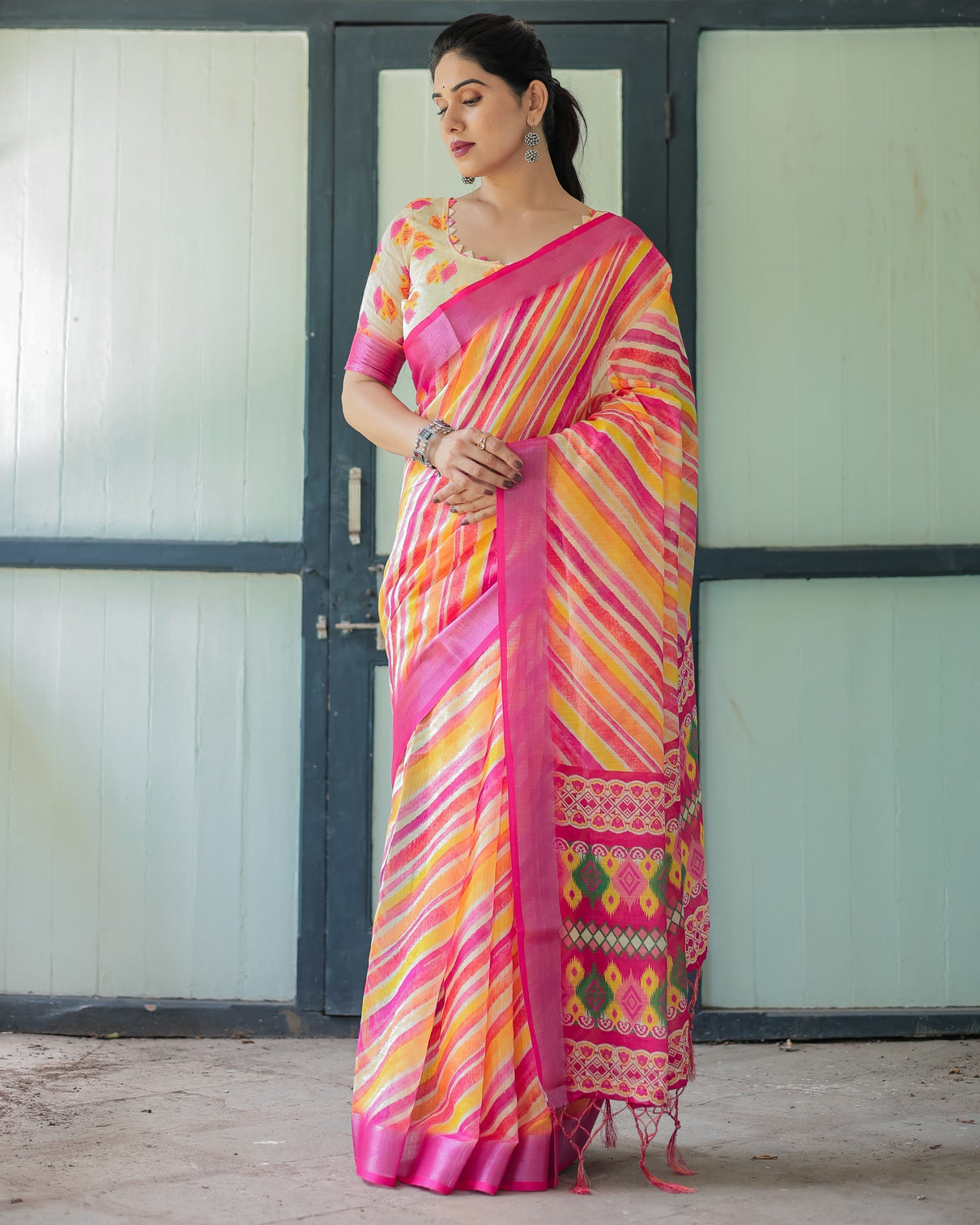 Vibrant yellow and pink ikat printed cotton linen saree with blouse and tassels