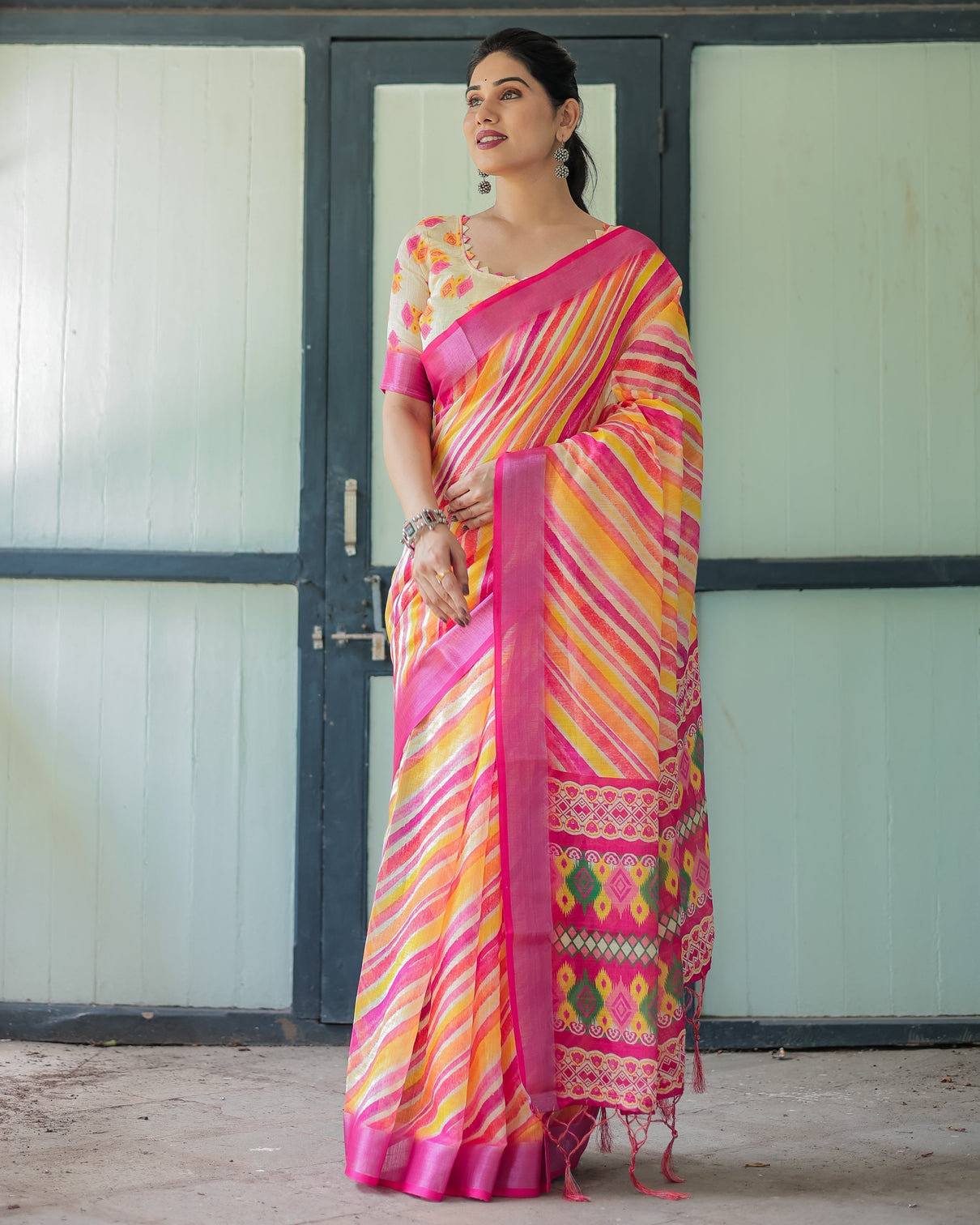 Vibrant yellow and pink ikat printed cotton linen saree with blouse and tassels