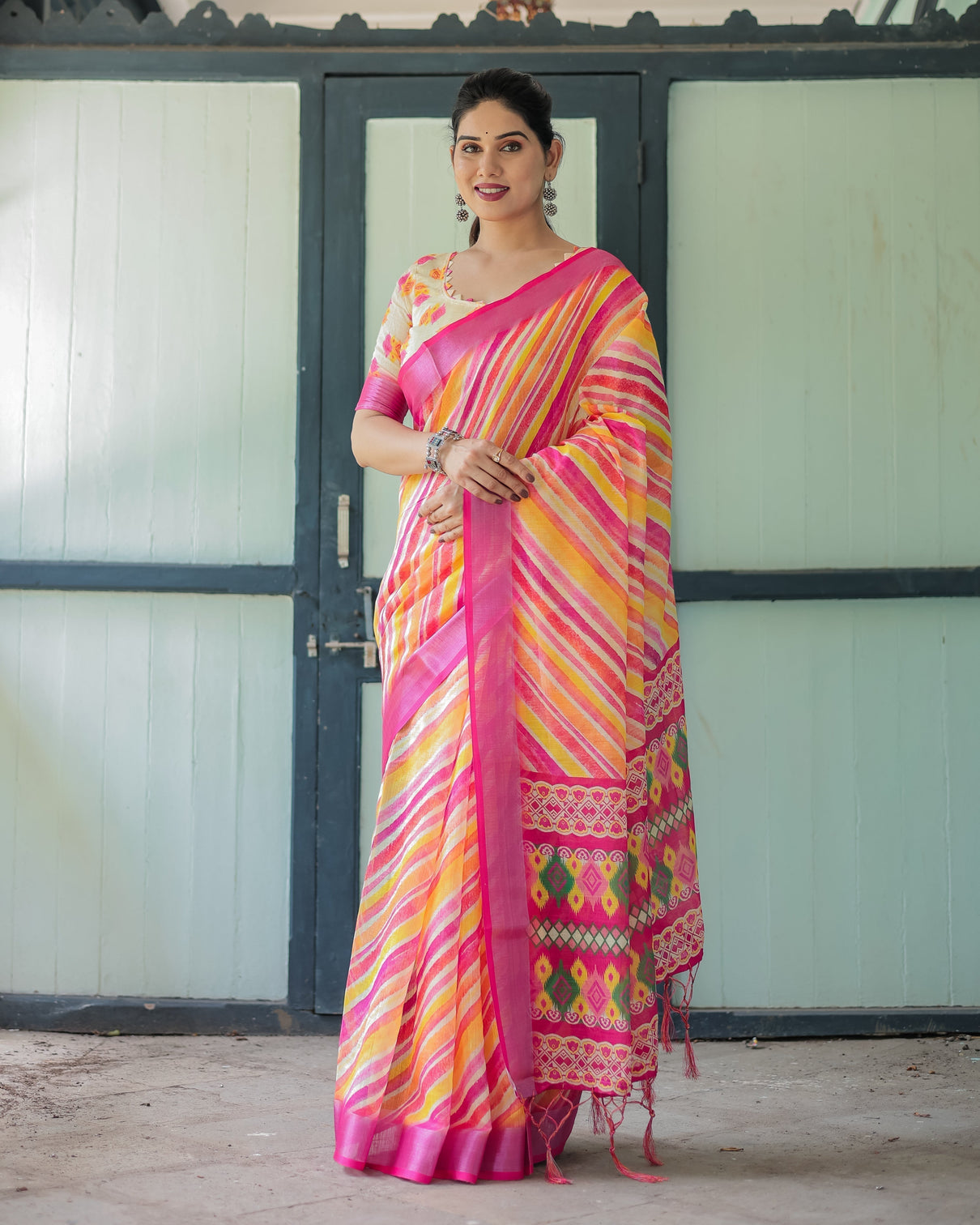 Vibrant yellow and pink ikat printed cotton linen saree with blouse and tassels