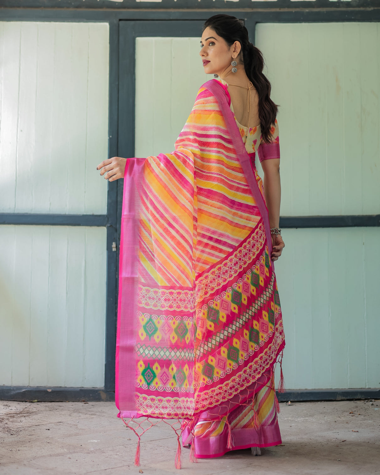 Vibrant yellow and pink ikat printed cotton linen saree with blouse and tassels