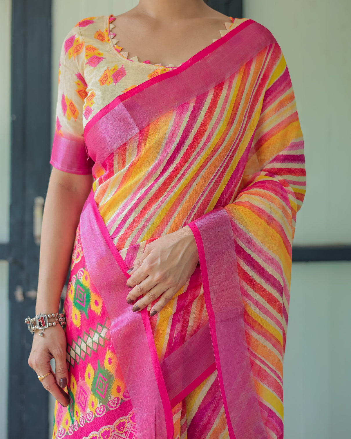 Vibrant yellow and pink ikat printed cotton linen saree with blouse and tassels
