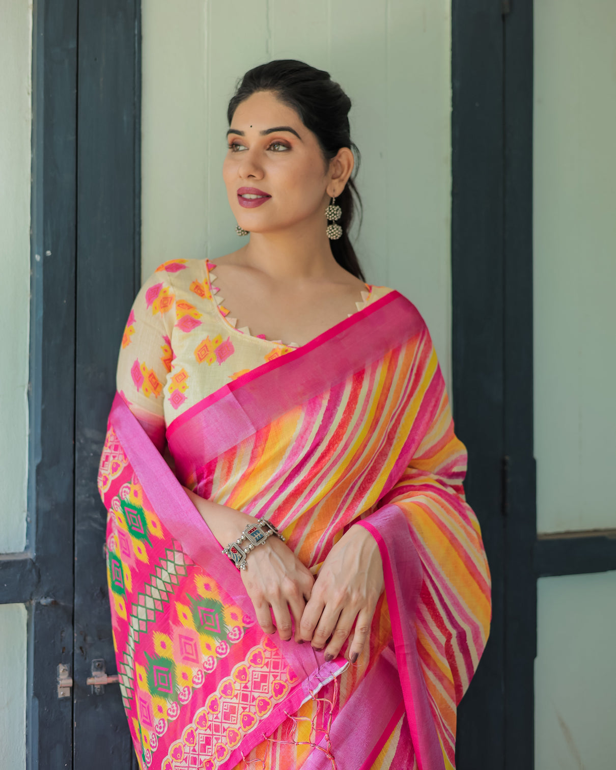 Vibrant yellow and pink ikat printed cotton linen saree with blouse and tassels