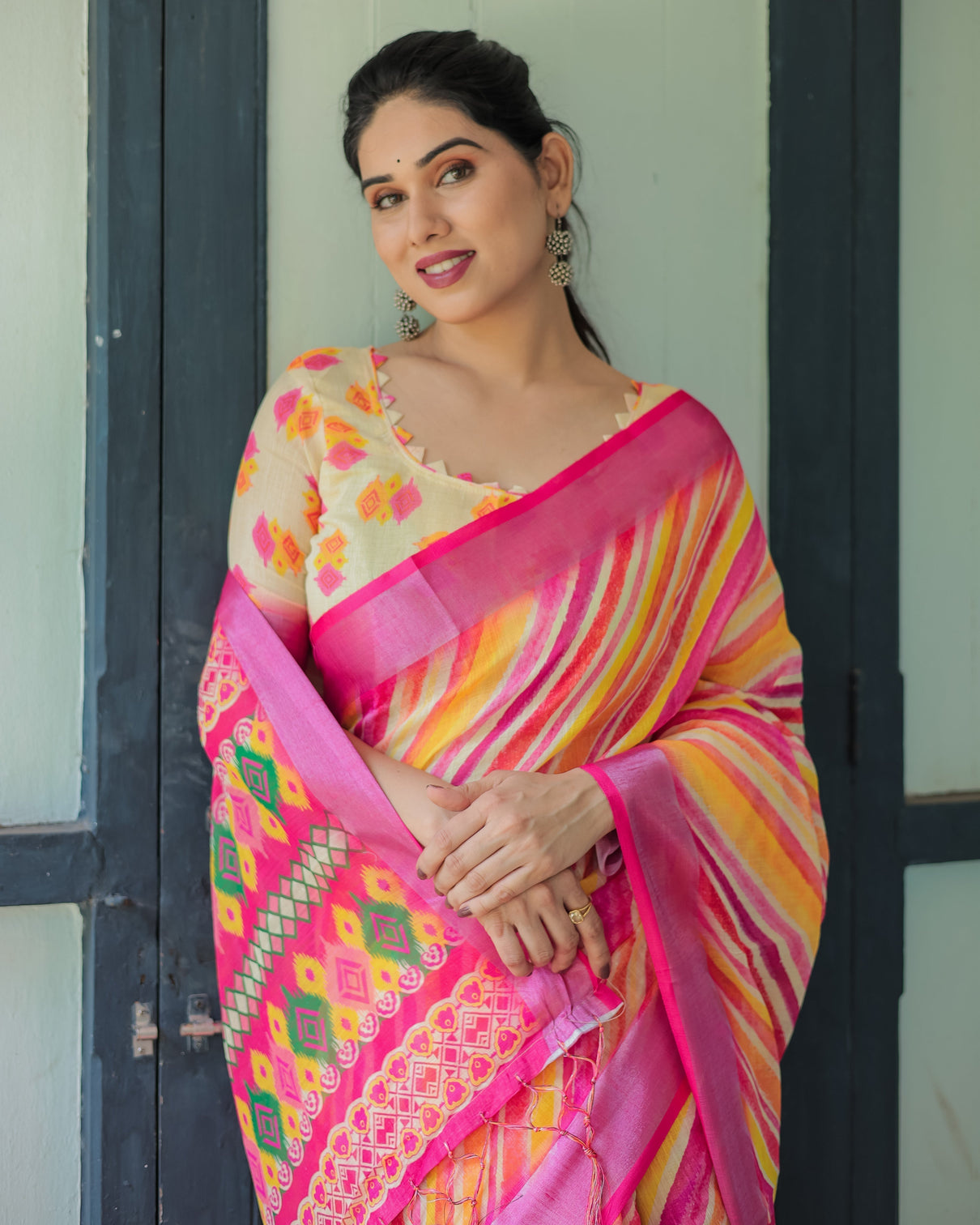 Vibrant yellow and pink ikat printed cotton linen saree with blouse and tassels
